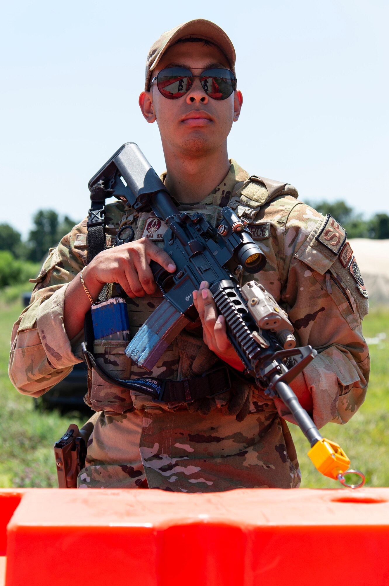 Senior Airman Shaun Jones, 436th Security Forces Squadron Raven, stands guard at a simulated forward operating base during Liberty Eagle Readiness Exercise 2022 at Dover Air Force Base, Delaware, July 12, 2022. The 436th and 512th Airlift Wings tested their ability to generate, employ and sustain airpower across the world in a simulated contested and degraded operational environment. (U.S. Air Force photo by Roland Balik)