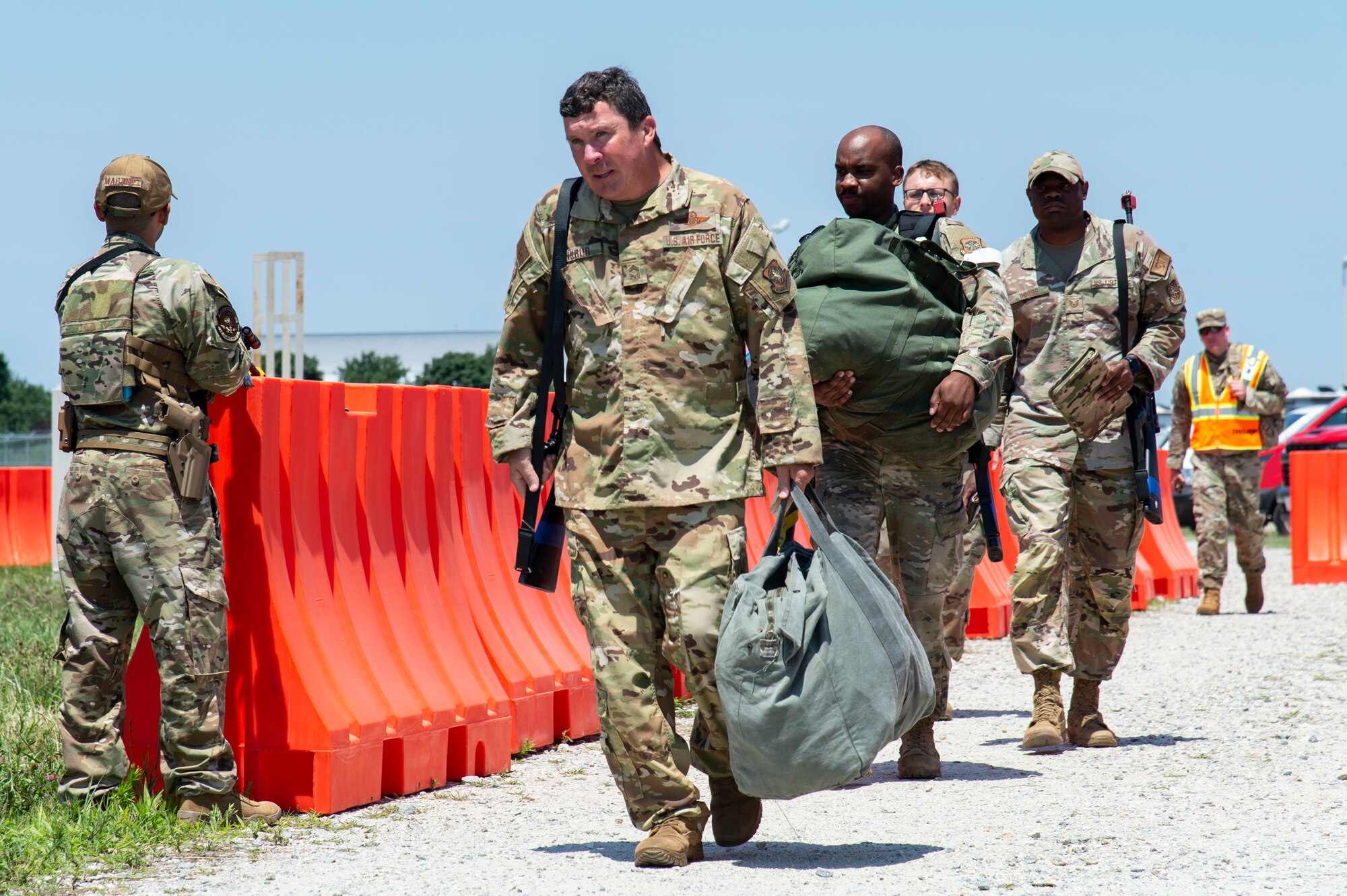 Team Dover members arrive at a simulated forward operating base during Liberty Eagle Readiness Exercise 2022 at Dover Air Force Base, Delaware, July 12, 2022. The 436th and 512th Airlift Wings tested their ability to generate, employ and sustain airpower across the world in a simulated contested and degraded operational environment. (U.S. Air Force photo by Roland Balik)