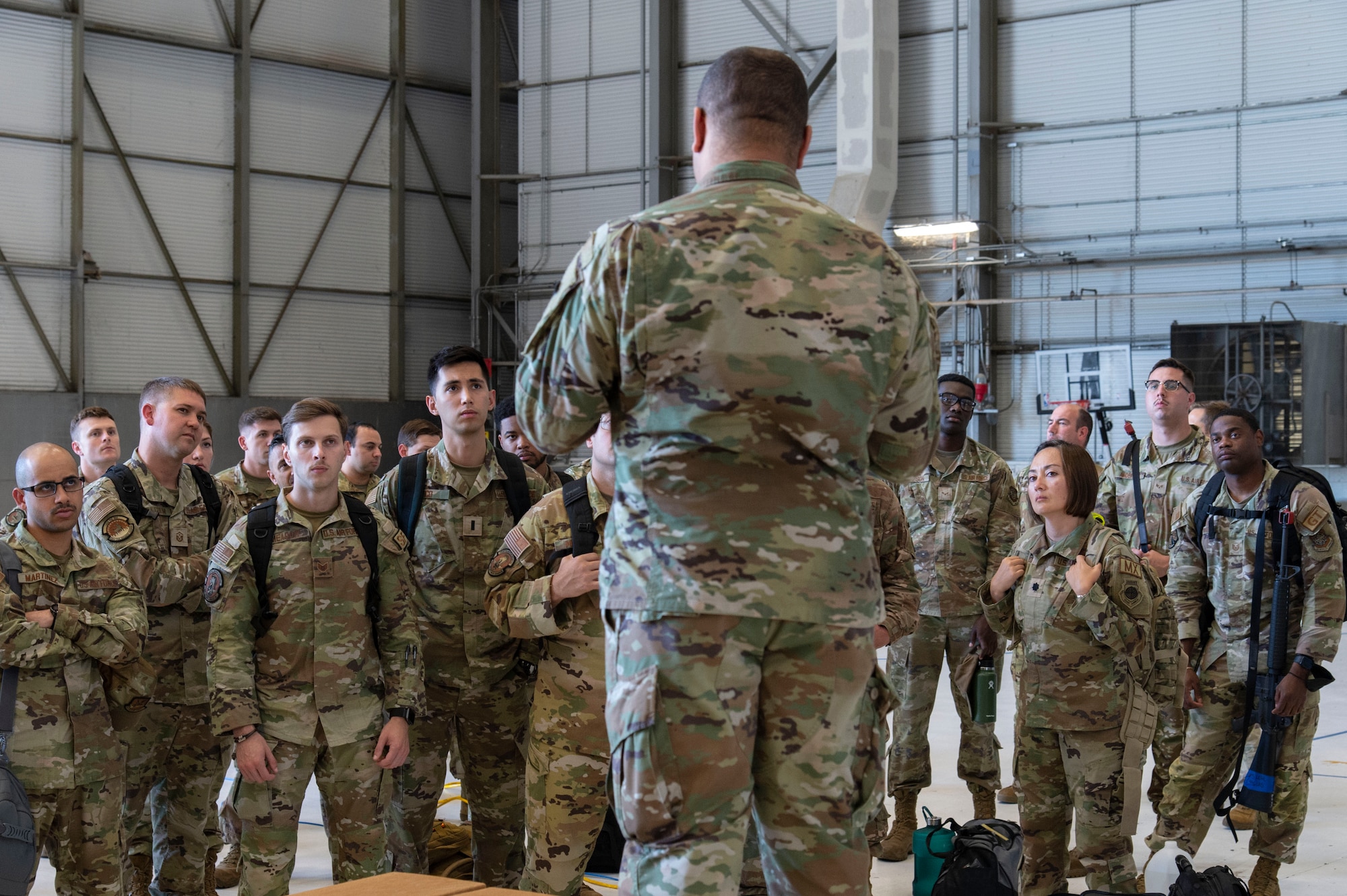 Staff Sgt. Tyler Hitchens, 512th Force Support Squadron assistant wing career advisor, briefs Team Dover members upon their arrival at a simulated deployment location during Liberty Eagle Readiness Exercise 2022 at Dover Air Force Base, Delaware, July 11, 2022. The 436th and 512th Airlift Wings tested their ability to generate, employ and sustain airpower across the world in a simulated contested and degraded operational environment. (U.S. Air Force photo by Roland Balik)