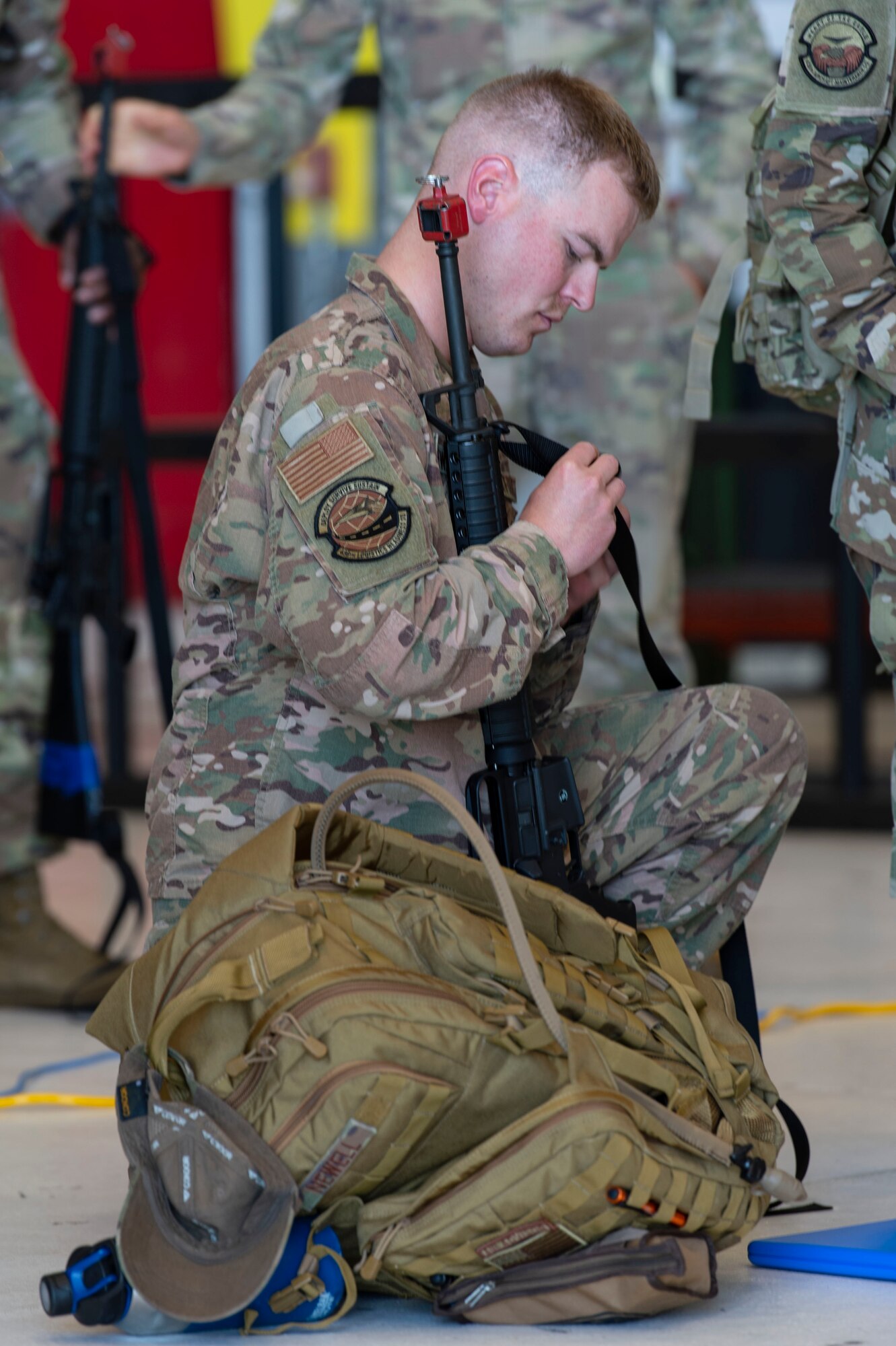 Tech. Sgt. Dalton Newell, 436th Logistics Readiness Squadron material control noncommissioned officer in charge, makes adjustments to his weapon strap during Liberty Eagle Readiness Exercise 2022 at Dover Air Force Base, Delaware, July 11, 2022. The 436th and 512th Airlift Wings tested their ability to generate, employ and sustain airpower across the world in a simulated contested and degraded operational environment. (U.S. Air Force photo by Roland Balik)