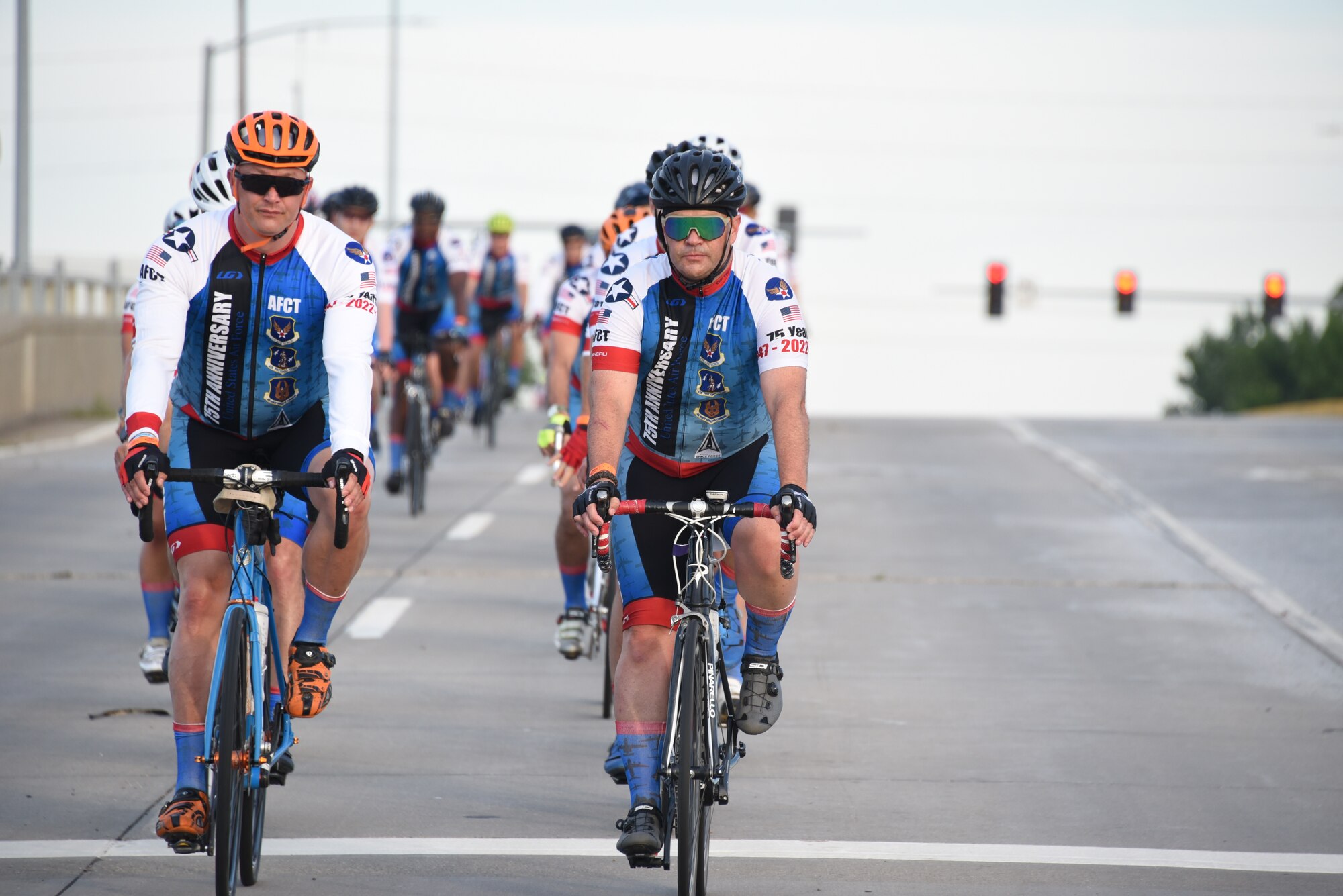 AFCT member ride two-by-two down a road