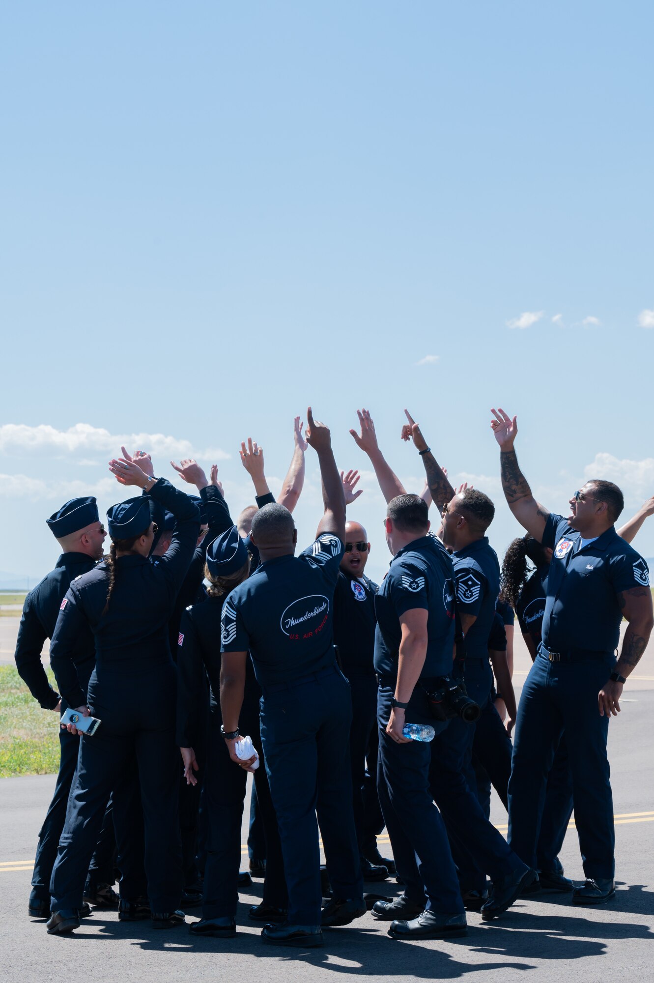 The U. S. Air Force Air Demonstration Squadron, known as the Thunderbirds, gather in a team huddle during Montana's Military Open House "Flight over the Falls" at Montana Air National Guard Base, Great Falls, Montana, July 23, 2022.