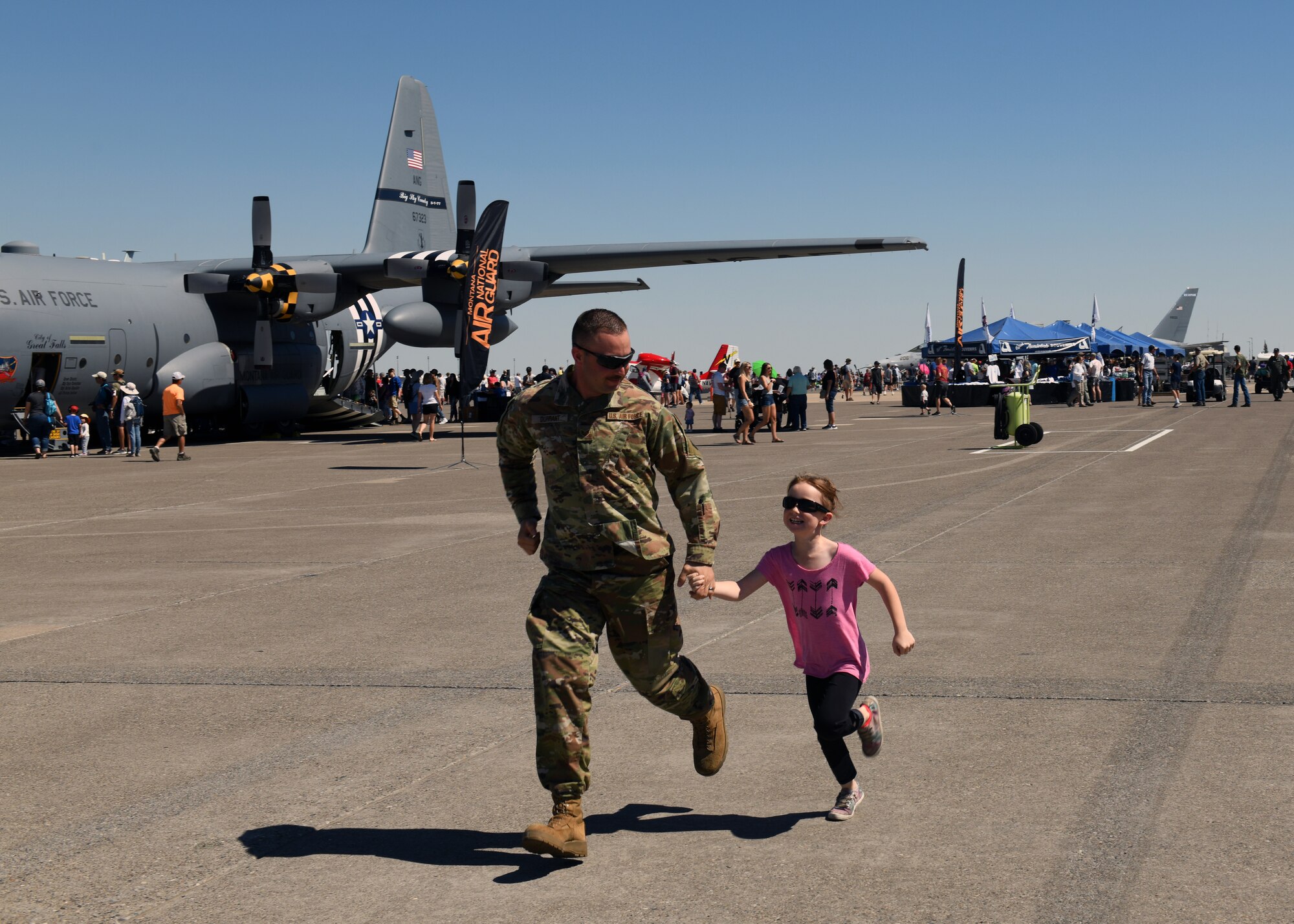 Spectators make their way hastily to a new attraction during
Montana's Military Open House "Flight over the Falls" at Montana Air National Guard Base, Great Falls, Montana, July 23, 2022.
