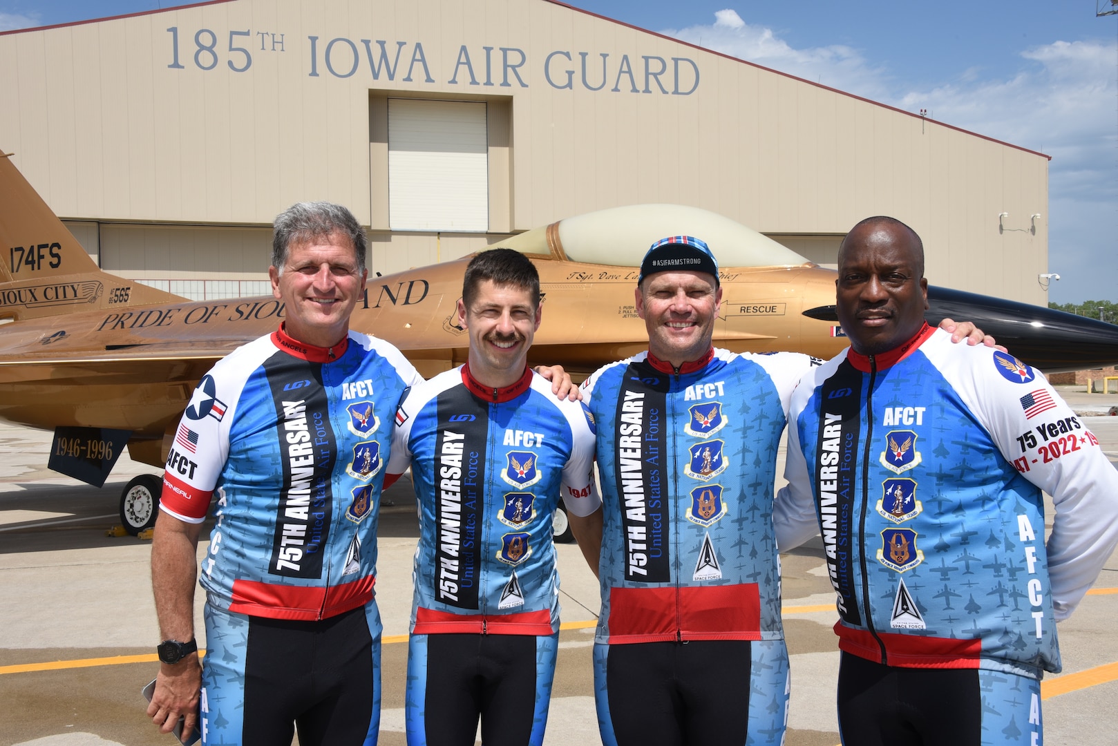 Four members of AFCT leadership pose in front of an F-16 Fighting Falcon