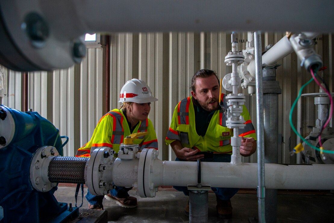 Zachary Smedley, Fuels Mechanical Engineer, U.S. Army Corps of Engineers, Omaha District, reviews the work done on the newly installed fuel tank pumping station with Portia Lenczowski, fuels section student trainee, at Offutt Air Force Base, Neb.,