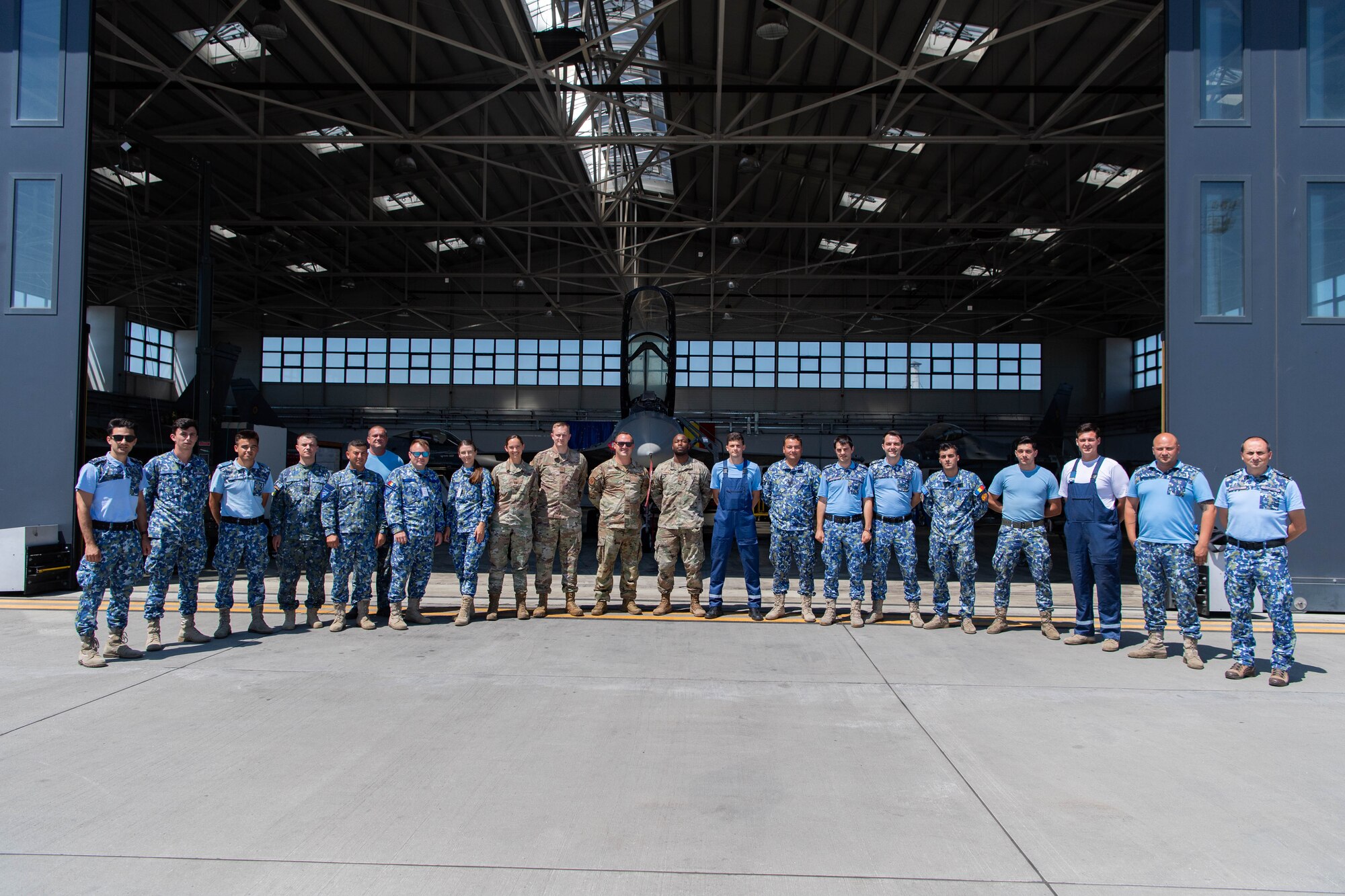 Service members stand for a photo.
