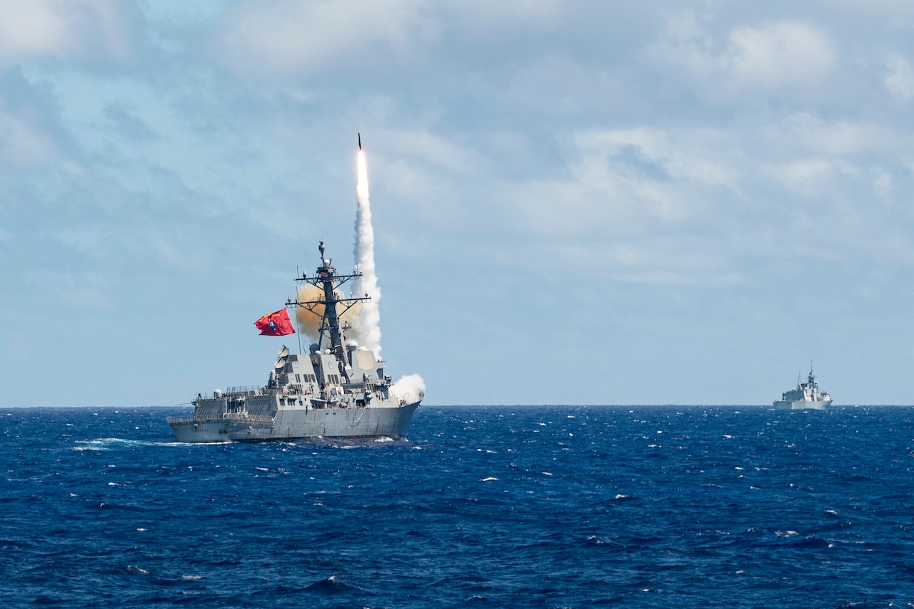 A missile is launched from a ship at sea.