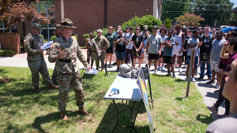 A Solider briefs high school students during summer camp.