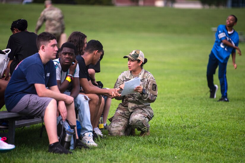 A Soldier coaches high school students during summer camp.