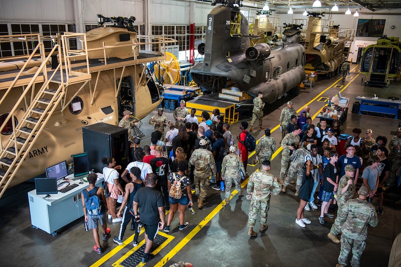 High school students tour helicopter simulators during summer camp.