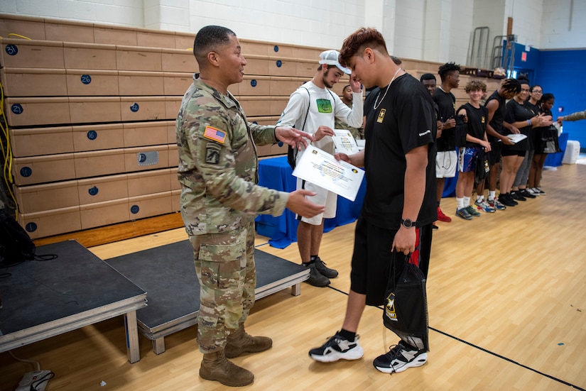 A high schooler is presented an award.