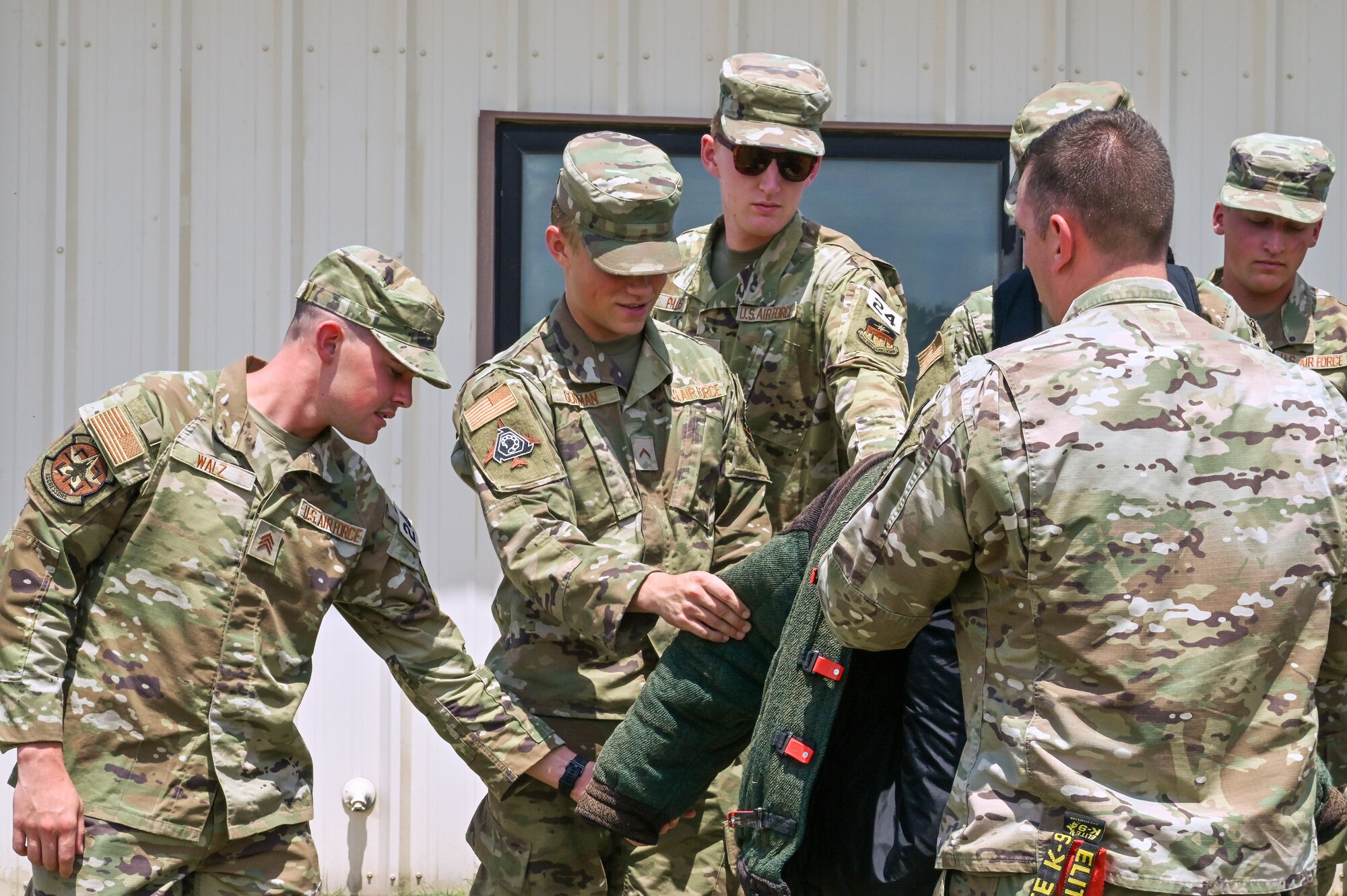 Technical Sergeant Jonathan Kuehne, 22nd Security Forces kennel master shows a group of United States Air Force Academy cadets a bite suit after a demonstration July 21, 2022, at McConnell Air Force Base, Kansas.