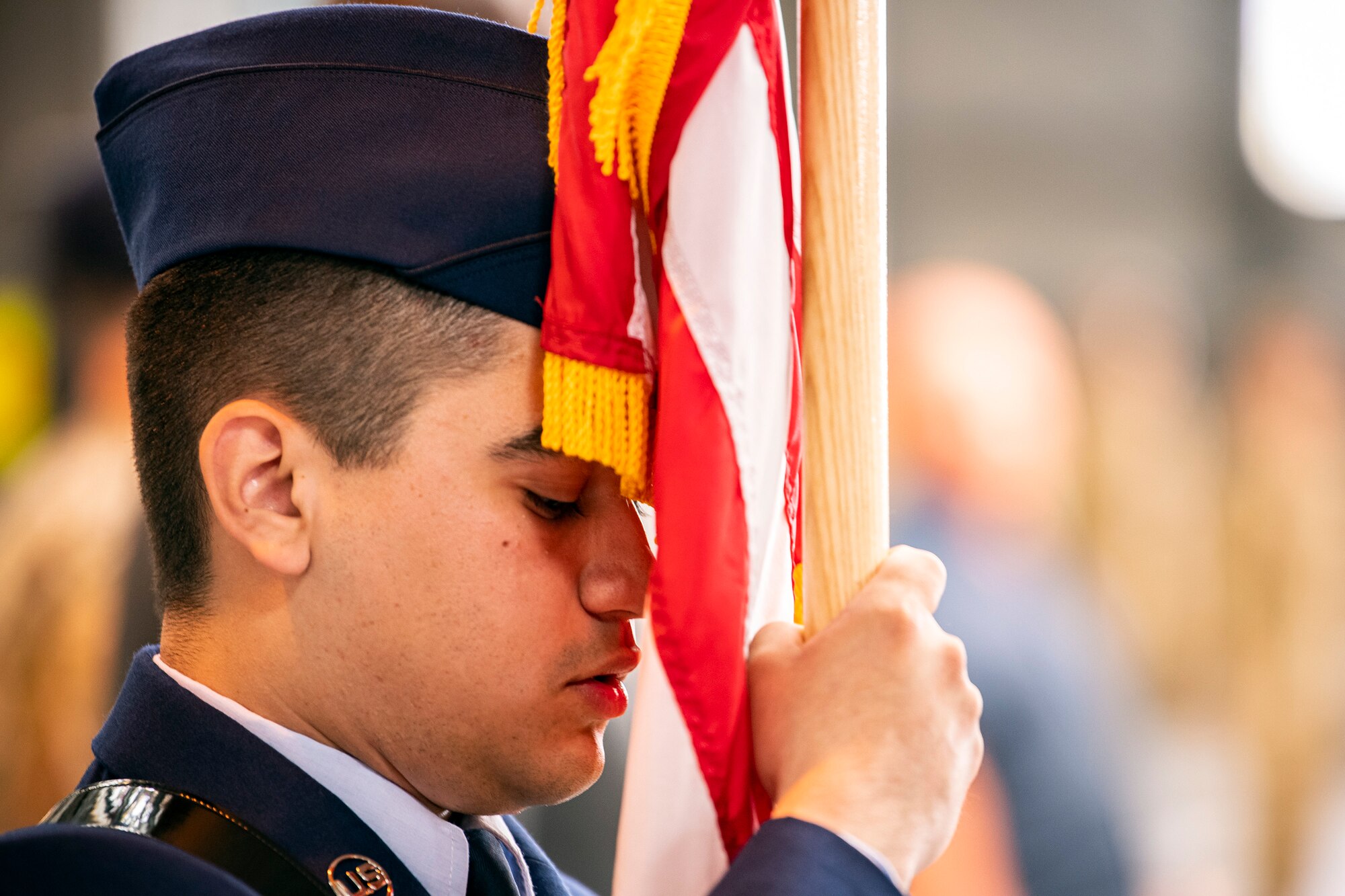 U.S. Air Force Airman Francisco Ruiz, 423d Communications Squadron client systems apprentice, holds a United States Flag during a change of command ceremony at RAF Alconbury, England, July 25, 2022. The ceremony is a military tradition that represents a formal transfer of a unit’s authority from one commander to another. (U.S. Air Force photo by Staff Sgt. Eugene Oliver)