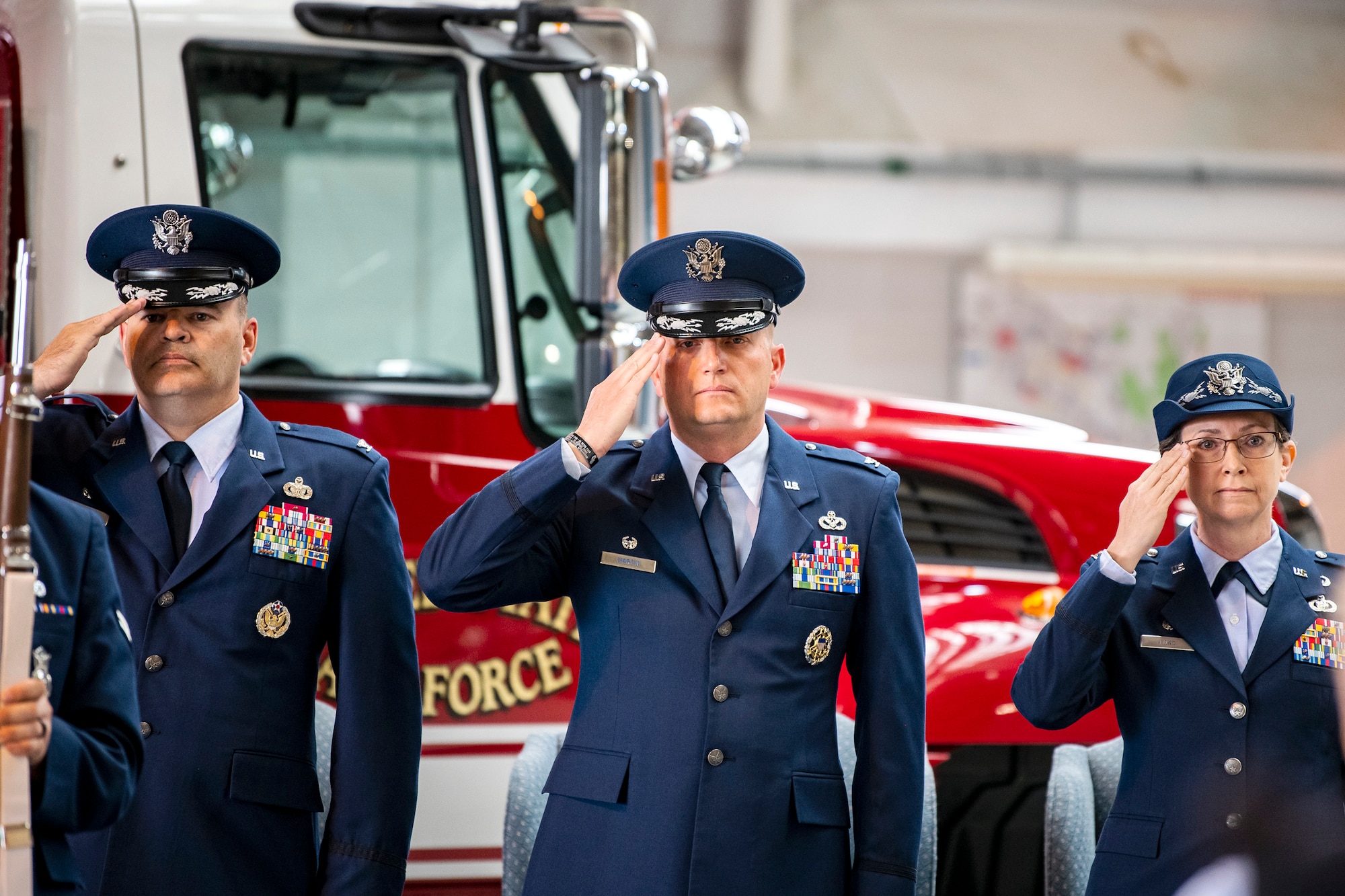 U.S. Air Force Col. Brian Filler, left, 501st Combat Support Wing commander, Col. Richard Martin, center, 423d Air Base Group outgoing commander, and Col. Valarie Long, 423d ABG incoming commander, salute during the national anthem at RAF Alconbury, England, July 25, 2022. During the ceremony, Martin relinquished command of the 423d ABG to Long. (U.S. Air Force photo by Staff Sgt. Eugene Oliver)