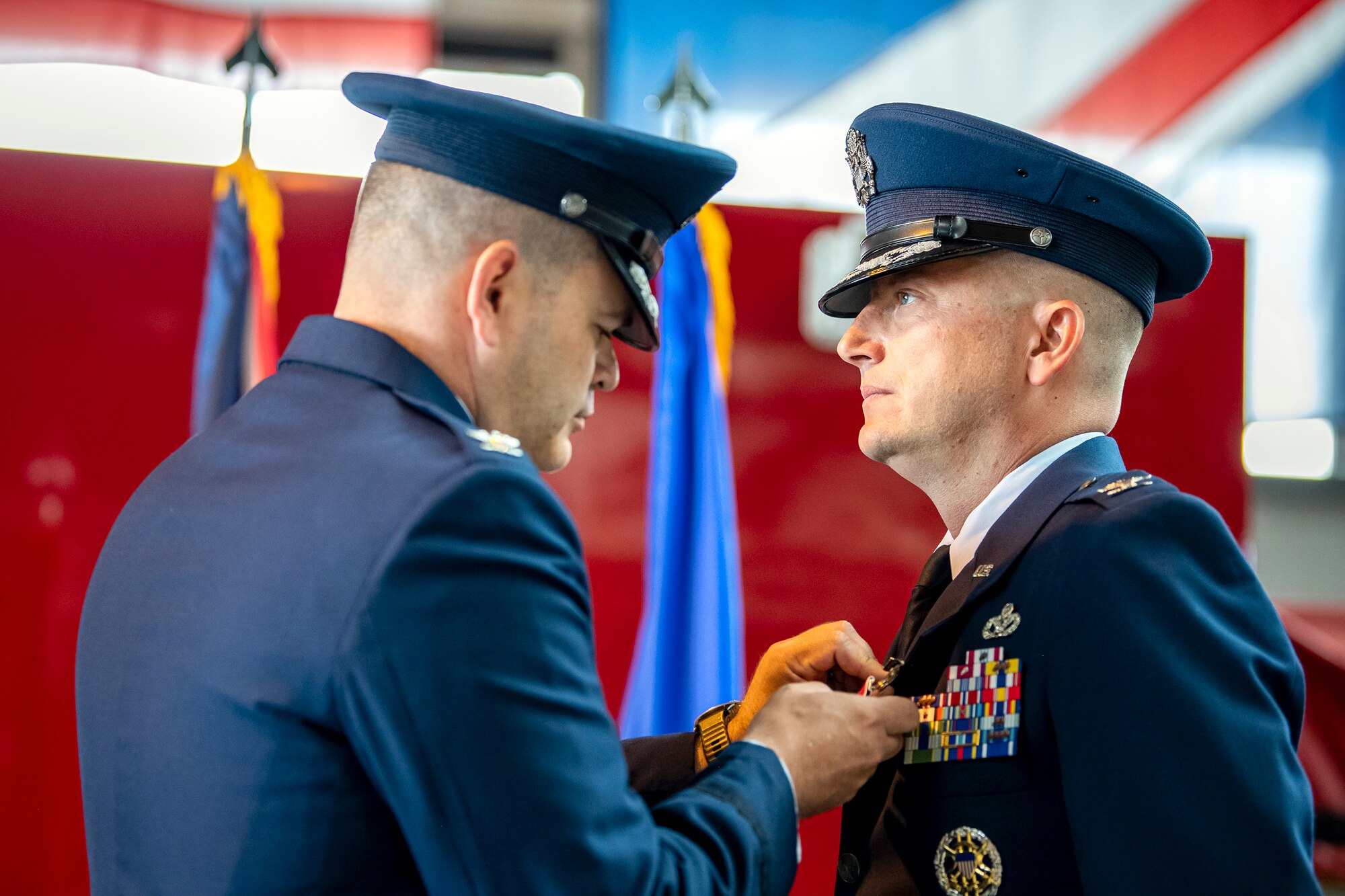 U.S. Air Force Col. Brian Filler, 501st Combat Support Wing commander, pins on the Legion of Merit medal to Col. Richard Martin, 423d Air Base Group outgoing commander, during a change of command ceremony at RAF Alconbury, England, July 25, 2022. During his command, Martin led a unit that provided a full range of operational, logistical, engineering, medical and communications support and community services to 6,500 military and civilian personnel and families at 4 installations. (U.S. Air Force photo by Staff Sgt. Eugene Oliver)