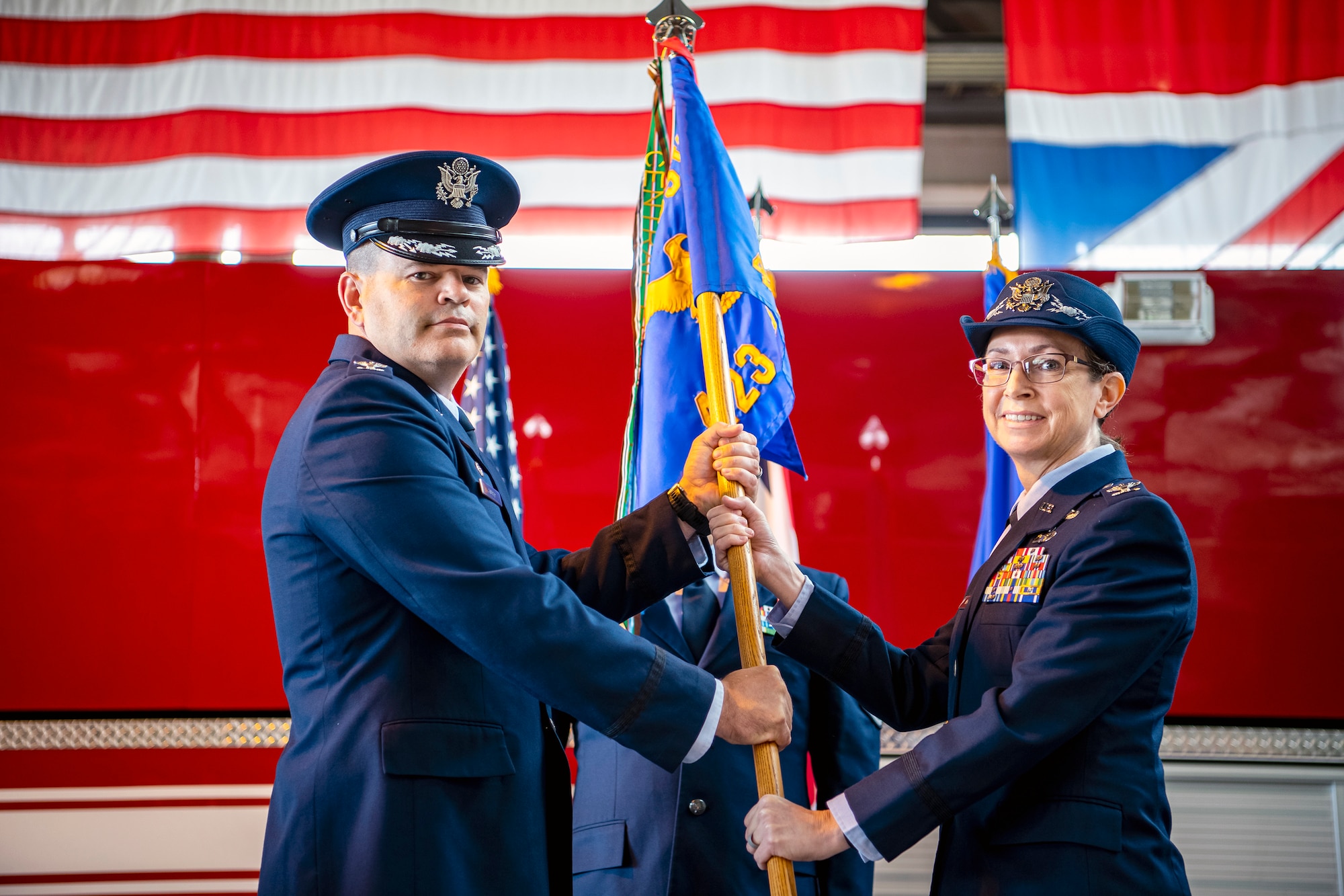 U.S. Air Force Col. Valarie Long, right, 423d Air Base Group incoming commander, receives the guidon from Col. Brian Filler, 501st Combat Support Wing commander, during a change of command ceremony at RAF Alconbury, England, July 25, 2022. Prior to assuming command, Long served as the Director of Information Warfare at the 603d Air Operations Center, Ramstein AB, Germany. (U.S. Air Force photo by Staff Sgt. Eugene Oliver)