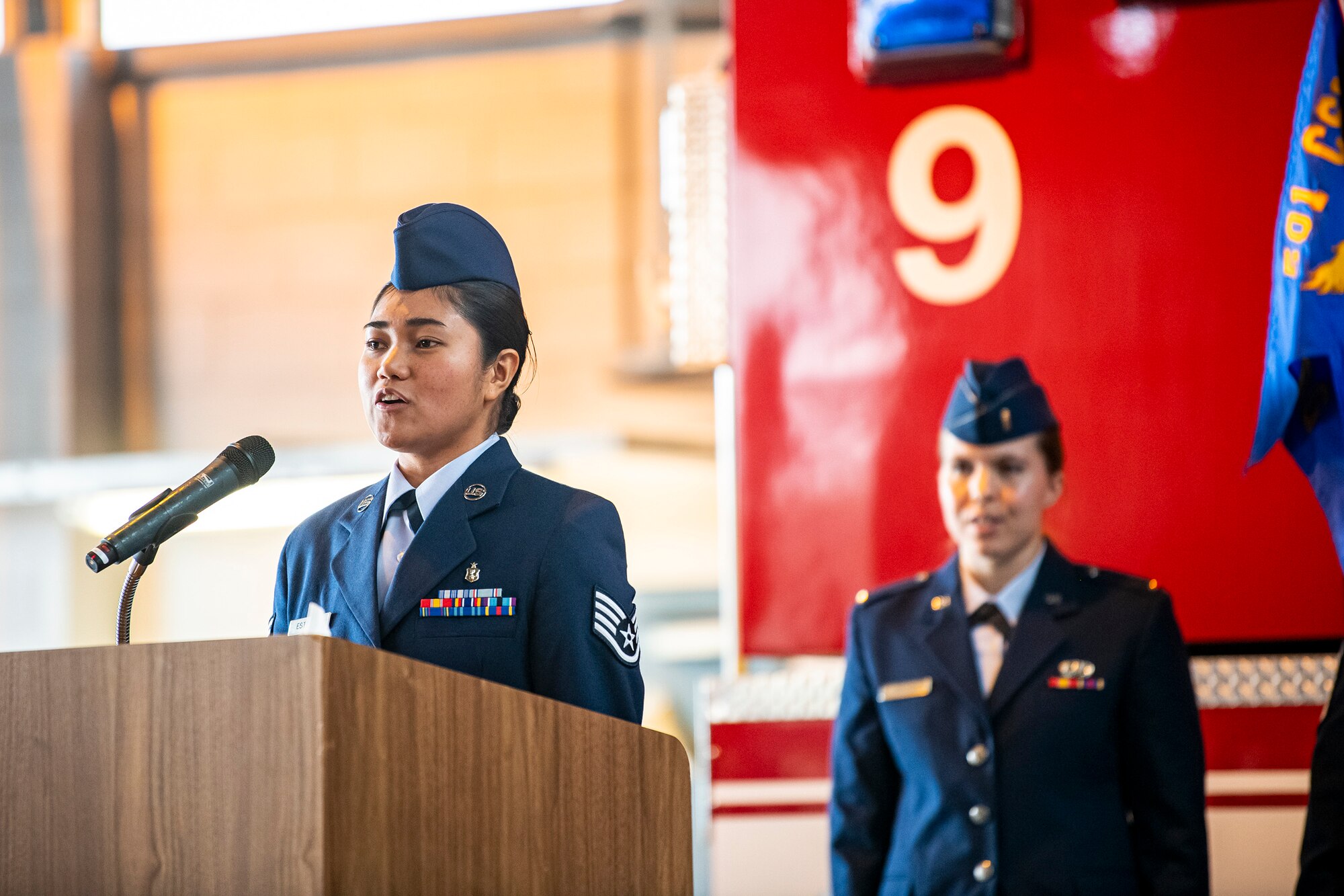 U.S. Air Force Staff Sgt. Bloom Esteller, left, 423d Medical Squadron dental assistant, sings the Air Force song at the conclusion of a change of command ceremony at RAF Alconbury, England, July 25, 2022. The ceremony is a military tradition that represents a formal transfer of a unit’s authority from one commander to another. (U.S. Air Force photo by Staff Sgt. Eugene Oliver)