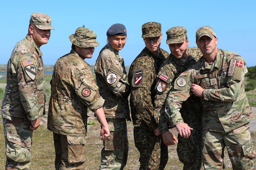 Participants for MREP 2022 work together on team building exercises at Camp Nymindegab July 3, 2022. MREP is a program that houses almost 130 participants from 6 different nations, to increase interoperability, strengthen partnerships, and to enhance professional development between allies.