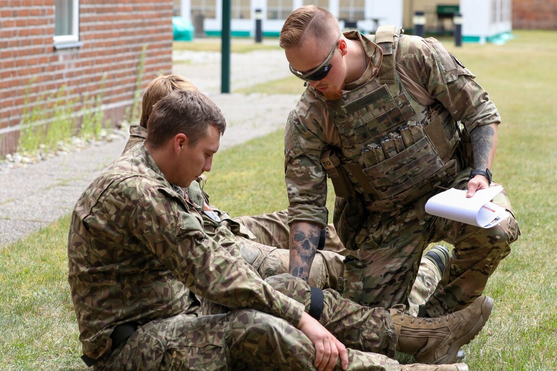 Participants for MREP 2022 work together on team building exercises at Camp Nymindegab July 4, 2022. MREP is a program that houses almost 130 participants from 6 different nations, to increase interoperability, strengthen partnerships, and to enhance professional development between allies.