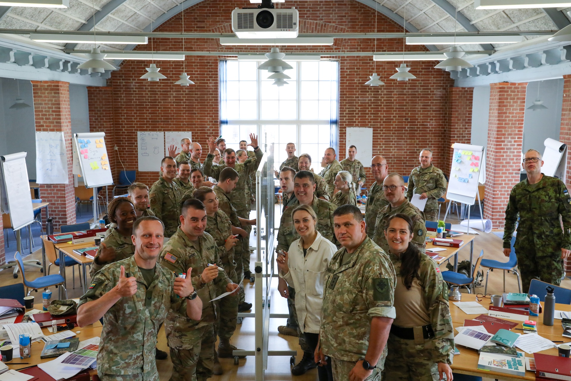 Participants for MREP 2022 work together on team building exercises at Camp Nymindegab July 4, 2022. MREP is a program that houses almost 130 participants from 6 different nations, to increase interoperability, strengthen partnerships, and to enhance professional development between allies.