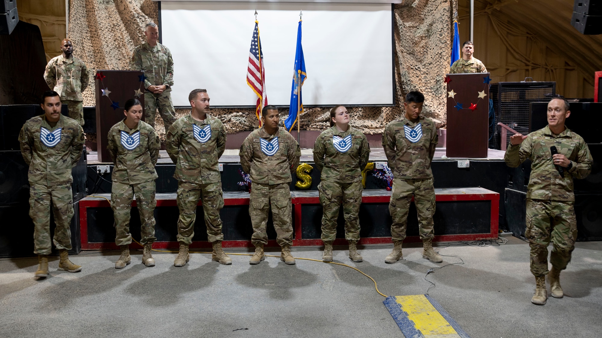 The 332d Air Expeditionary Wing celebrates with an E-6 release party for those Airmen selected to promote to Technical Sergeant at an undisclosed location in Southwest Asia, July 23, 2022. 332d AEW Commander Brigadier General R. Ryan Messer along with Command Chief Master Sergeant Kevin M. Eberlin help celebrate the occasion. Promotion to TSgt is very competitive, this year the promotion rate is only 16%. Promotions exemplify technical skills, leadership, and a standard of excellence. (U.S Air Force photo by Tech. Sgt. Jeffery Foster)