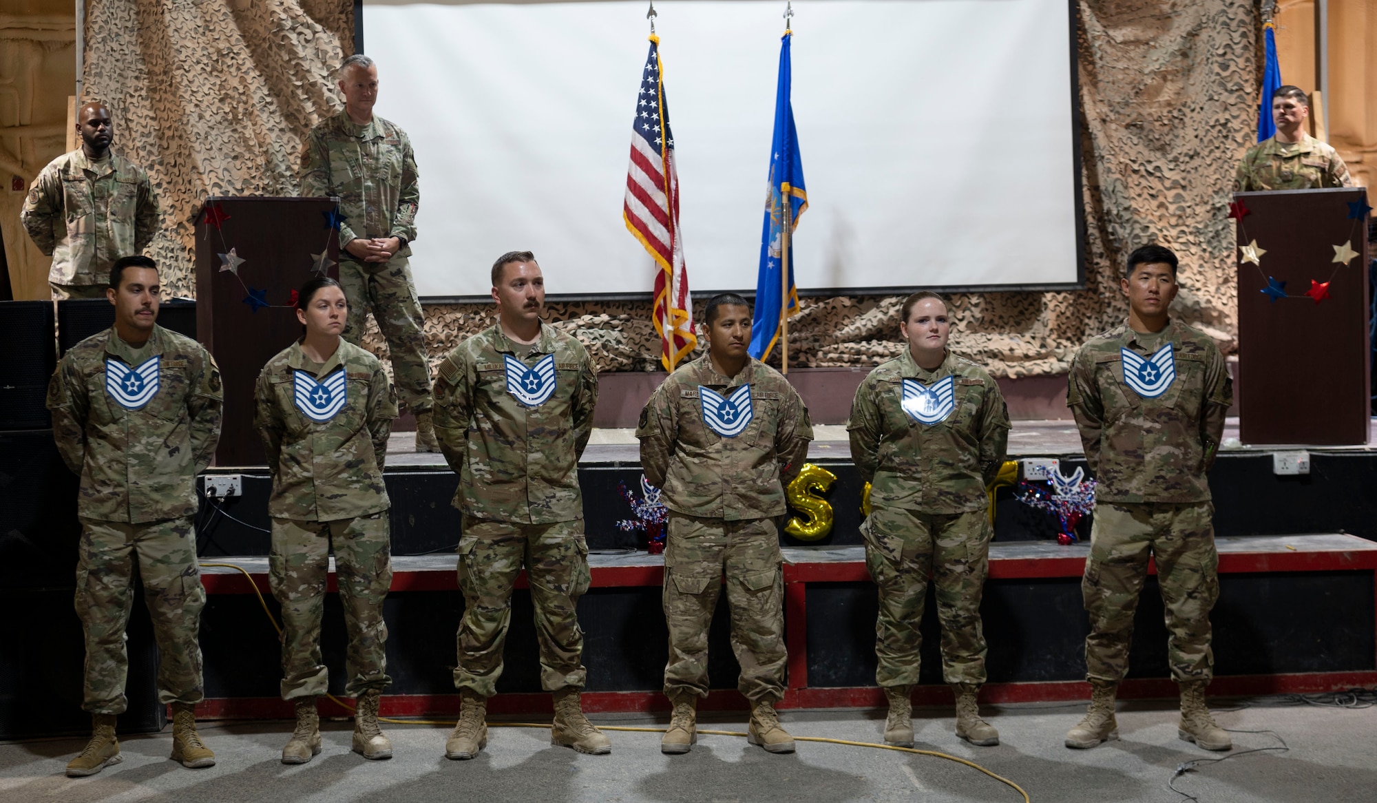 The 332d Air Expeditionary Wing celebrates with an E-6 release party for those Airmen selected to promote to Technical Sergeant at an undisclosed location in Southwest Asia, July 23, 2022. 332d AEW Commander Brigadier General R. Ryan Messer along with Command Chief Master Sergeant Kevin M. Eberlin help celebrate the occasion. Promotion to TSgt is very competitive, this year the promotion rate is only 16%. Promotions exemplify technical skills, leadership, and a standard of excellence. (U.S Air Force photo by Tech. Sgt. Jeffery Foster)