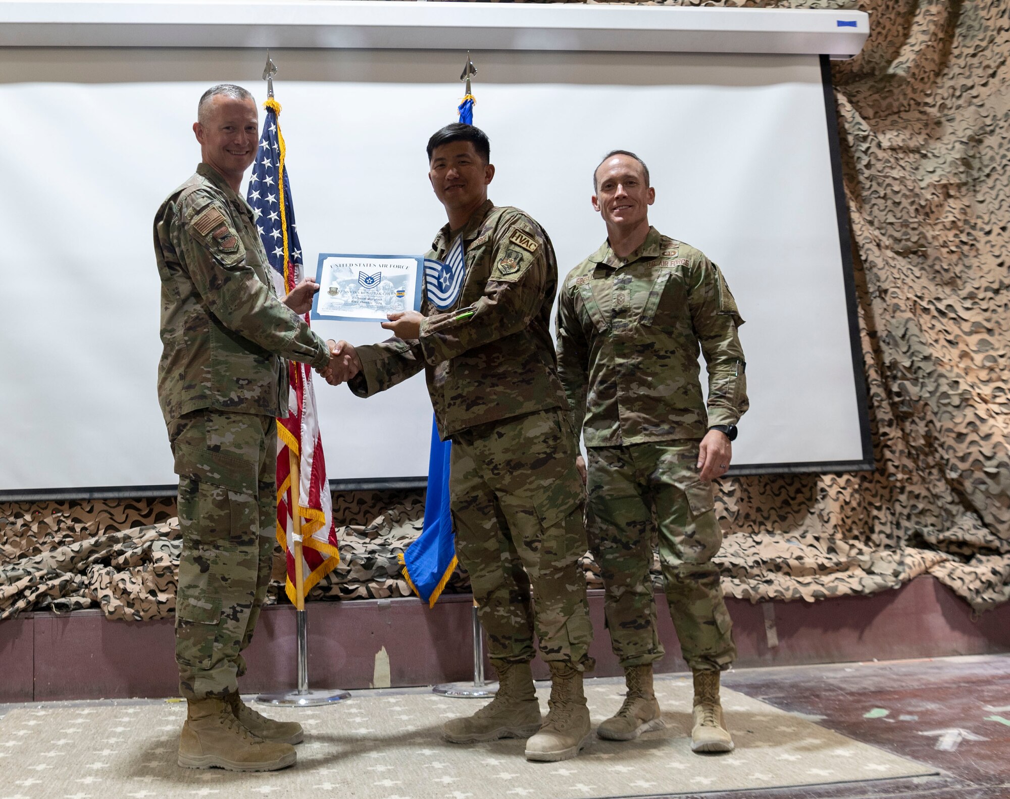 The 332d Air Expeditionary Wing celebrates with an E-6 release party for those Airmen selected to promote to Technical Sergeant at an undisclosed location in Southwest Asia, July 23, 2022. 332d AEW Commander Brigadier General R. Ryan Messer along with Command Chief Master Sergeant Kevin M. Eberlin help celebrate the occasion. Promotion to TSgt is very competitive, this year the promotion rate is only 16%. Promotions exemplify technical skills, leadership, and a standard of excellence. (U.S Air Force photo by Tech. Sgt. Jeffery Foster)