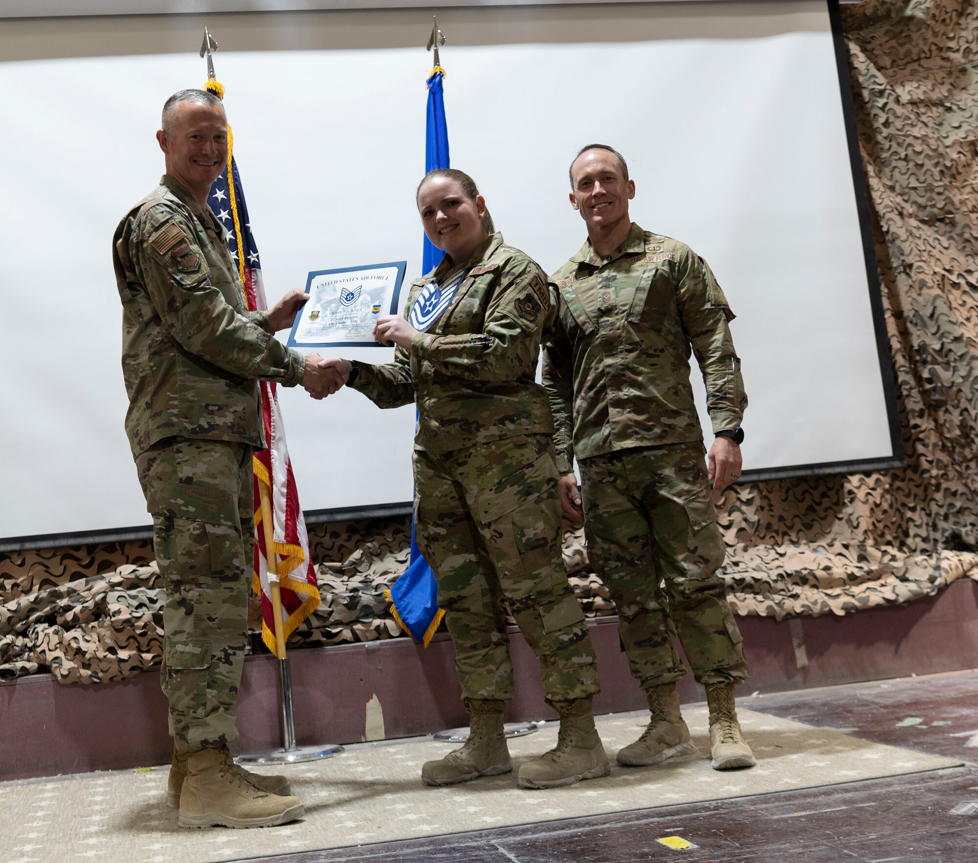 The 332d Air Expeditionary Wing celebrates with an E-6 release party for those Airmen selected to promote to Technical Sergeant at an undisclosed location in Southwest Asia, July 23, 2022. 332d AEW Commander Brigadier General R. Ryan Messer along with Command Chief Master Sergeant Kevin M. Eberlin help celebrate the occasion. Promotion to TSgt is very competitive, this year the promotion rate is only 16%. Promotions exemplify technical skills, leadership, and a standard of excellence. (U.S Air Force photo by Tech. Sgt. Jeffery Foster)