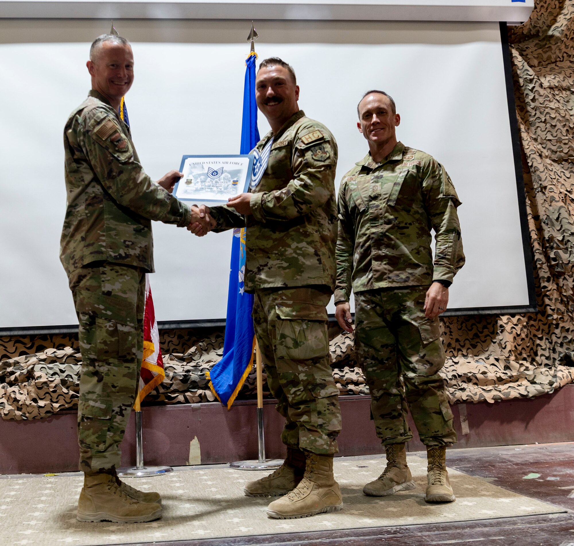 The 332d Air Expeditionary Wing celebrates with an E-6 release party for those Airmen selected to promote to Technical Sergeant at an undisclosed location in Southwest Asia, July 23, 2022. 332d AEW Commander Brigadier General R. Ryan Messer along with Command Chief Master Sergeant Kevin M. Eberlin help celebrate the occasion. Promotion to TSgt is very competitive, this year the promotion rate is only 16%. Promotions exemplify technical skills, leadership, and a standard of excellence. (U.S Air Force photo by Tech. Sgt. Jeffery Foster)