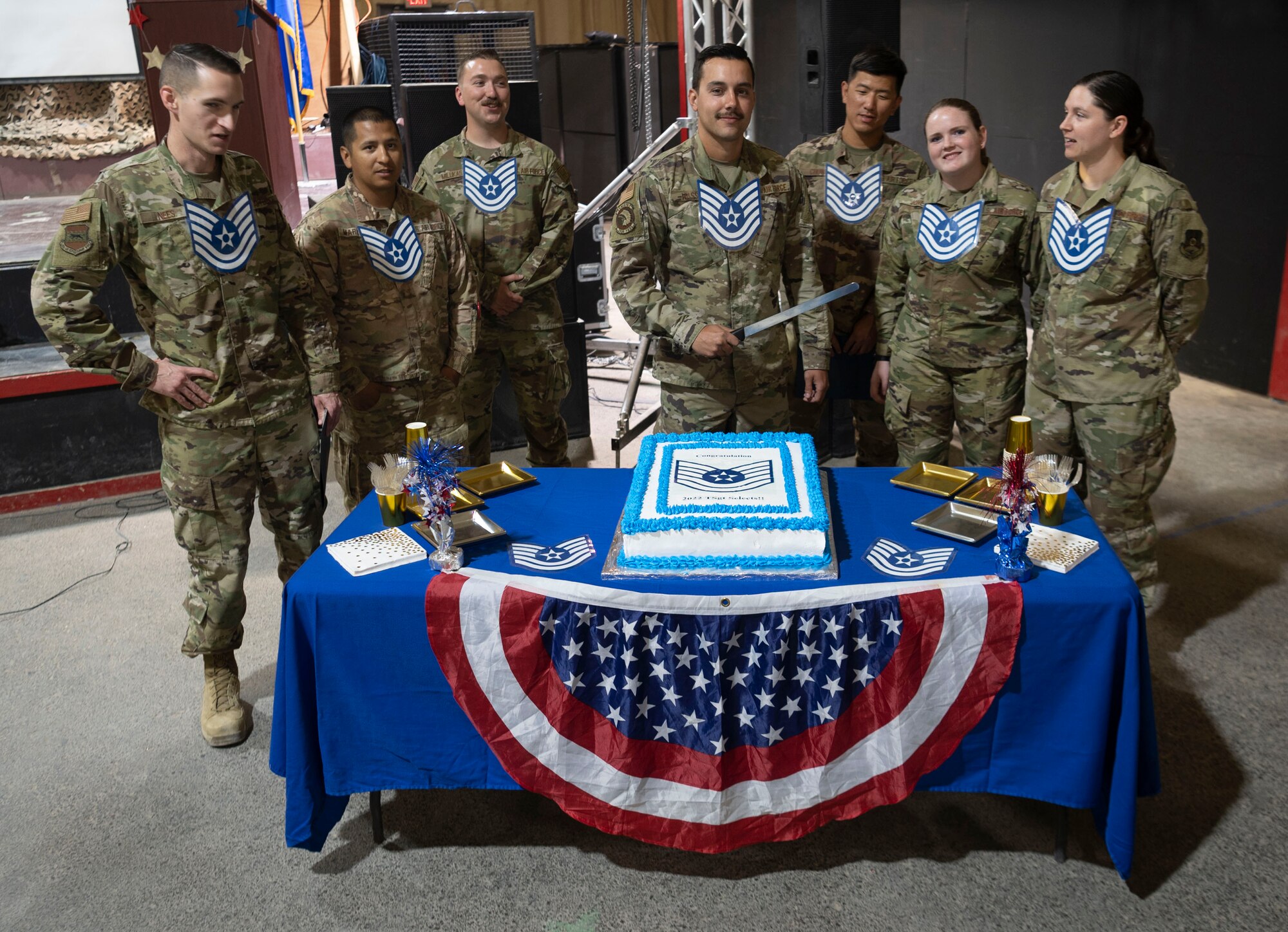 The 332d Air Expeditionary Wing celebrates with an E-6 release party for those Airmen selected to promote to Technical Sergeant at an undisclosed location in Southwest Asia, July 23, 2022. 332d AEW Commander Brigadier General R. Ryan Messer along with Command Chief Master Sergeant Kevin M. Eberlin help celebrate the occasion. Promotion to TSgt is very competitive, this year the promotion rate is only 16%. Promotions exemplify technical skills, leadership, and a standard of excellence. (U.S Air Force photo by Tech. Sgt. Jeffery Foster)