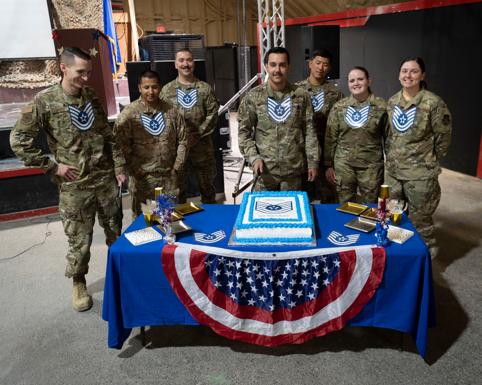 The 332d Air Expeditionary Wing celebrates with an E-6 release party for those Airmen selected to promote to Technical Sergeant at an undisclosed location in Southwest Asia, July 23, 2022. 332d AEW Commander Brigadier General R. Ryan Messer along with Command Chief Master Sergeant Kevin M. Eberlin help celebrate the occasion. Promotion to TSgt is very competitive, this year the promotion rate is only 16%. Promotions exemplify technical skills, leadership, and a standard of excellence. (U.S Air Force photo by Tech. Sgt. Jeffery Foster)