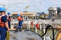 220725-G-XT974-1009
U.S. Coast Guard Fireman Juan Ayala throws a heaving line aboard the Famous-class medium endurance cutter USCGC Mohawk (WMEC 913) before arriving in Banjul, Gambia, July 25, 2022. USCGC Mohawk is on a scheduled deployment in the U.S. Naval Forces Africa area of operations, employed by U.S. Sixth Fleet to defend U.S., allied, and partner interests. (U.S. Coast Guard photo by Petty Officer 3rd Class Jessica Fontenette)