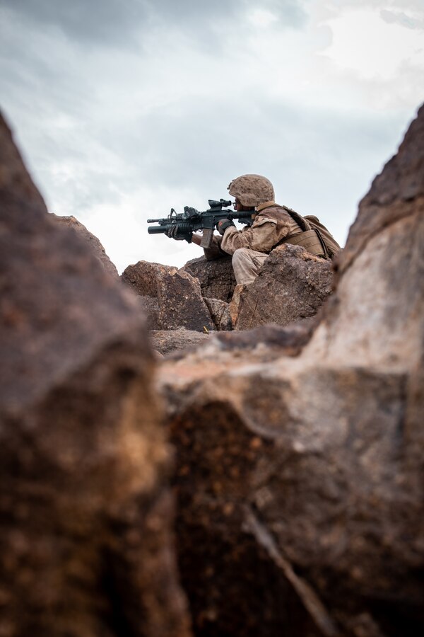 U.S. Marine Corps Lance Cpl. Jesus Campos-Gaona, a squad automatic rifleman with India Company, 3rd Battalion, 23rd Marine Regiment, 4th Marine Division, Marine Forces Reserve, from De Queen, Arizona, marks his target while executing Range 400 during Integrated Training Exercise (ITX) 4-22 at Marine Corps Air Ground Combat Center, Twentynine Palms, Calif., July 23, 2022.  Range 400 is used to conduct company-level live-fire training in a deliberate assault against prepared defensive positions. ITX is designed to provide large forces the opportunity to command and control their Marines through a live-fire program incorporating every element of the MAGTF. (U.S. Marine Corps photo by Lance Cpl. David Intriago)