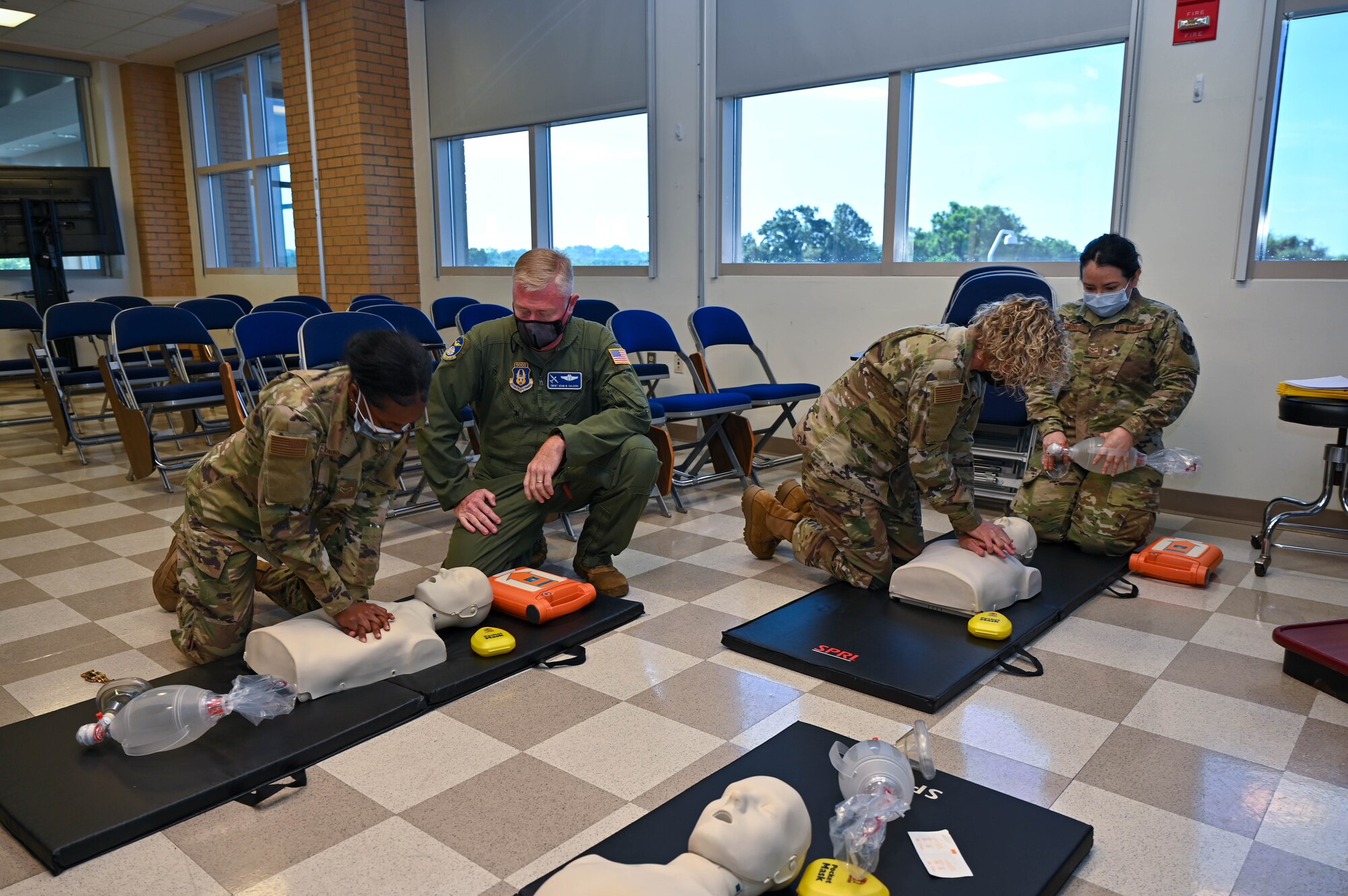 students practice CPR