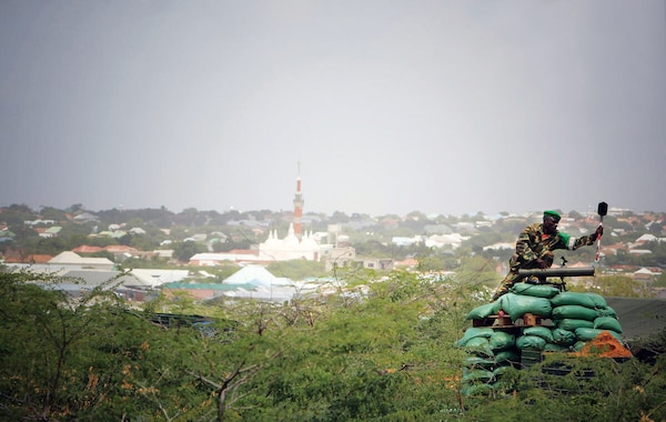 Burundian soldier serving with African Union Mission in Somalia cleans rocket launcher against Mogadishu skyline after sudden
departure of al-Shabaab, August 18, 2011 (United Nations/Stuart Price)