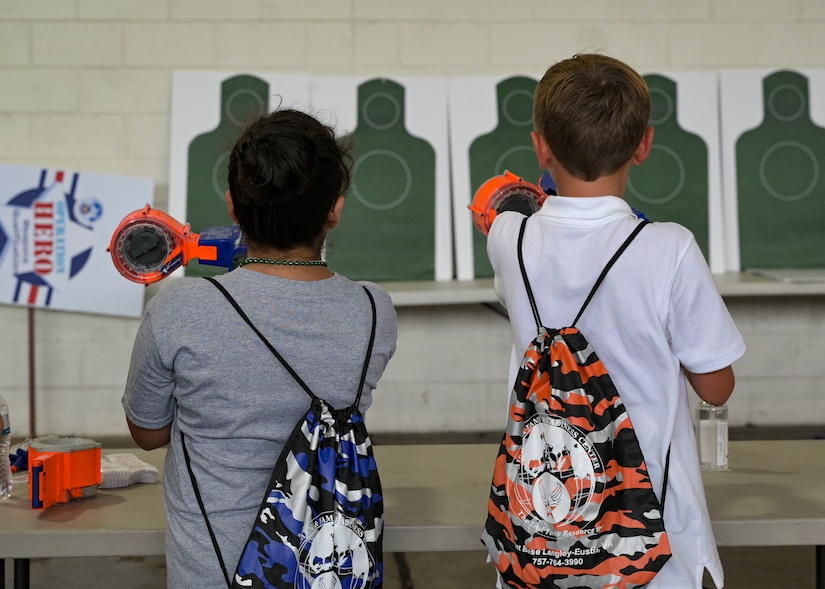 Children shoot toy weapons at targets