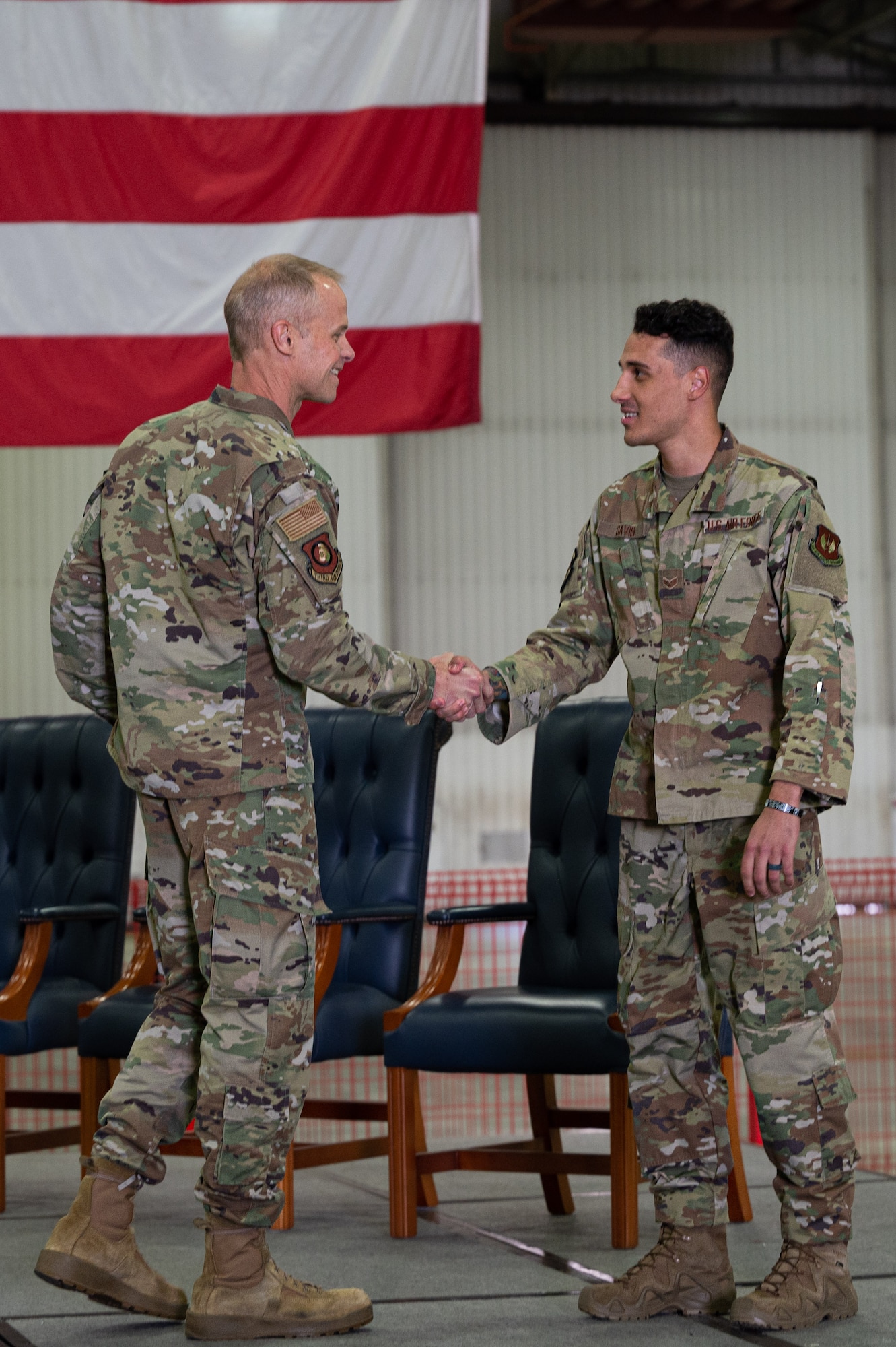 U.S. Air Force Maj. Gen. Derek France, 3rd Air Force commander, coins Senior Airman Demarion Davis, 48th Communications Squadron TEMPEST Manager, on his announcement of being named one of the 12 Outstanding Airmen of the Year, June 28, 2022 at Royal Air Force Lakenheath, England.