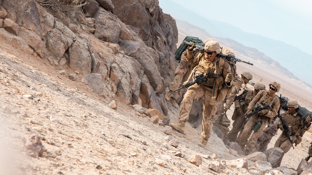 U.S. Marines with 3rd Battalion, 23rd Marine Regiment, 4th Marine Division, Marine Forces Reserve, advance towards their support by fire position at Range 400 during Integrated Training Exercise 4-22 at Marine Corps Air-Ground Combat Center, Twentynine Palms, Calif., July 23, 2022.  Range 400 is used to conduct company-level live-fire training in a deliberate assault against prepared defensive positions. ITX is designed to provide large forces the opportunity to command and control their Marines through a live-fire program incorporating every element of the MAGTF.