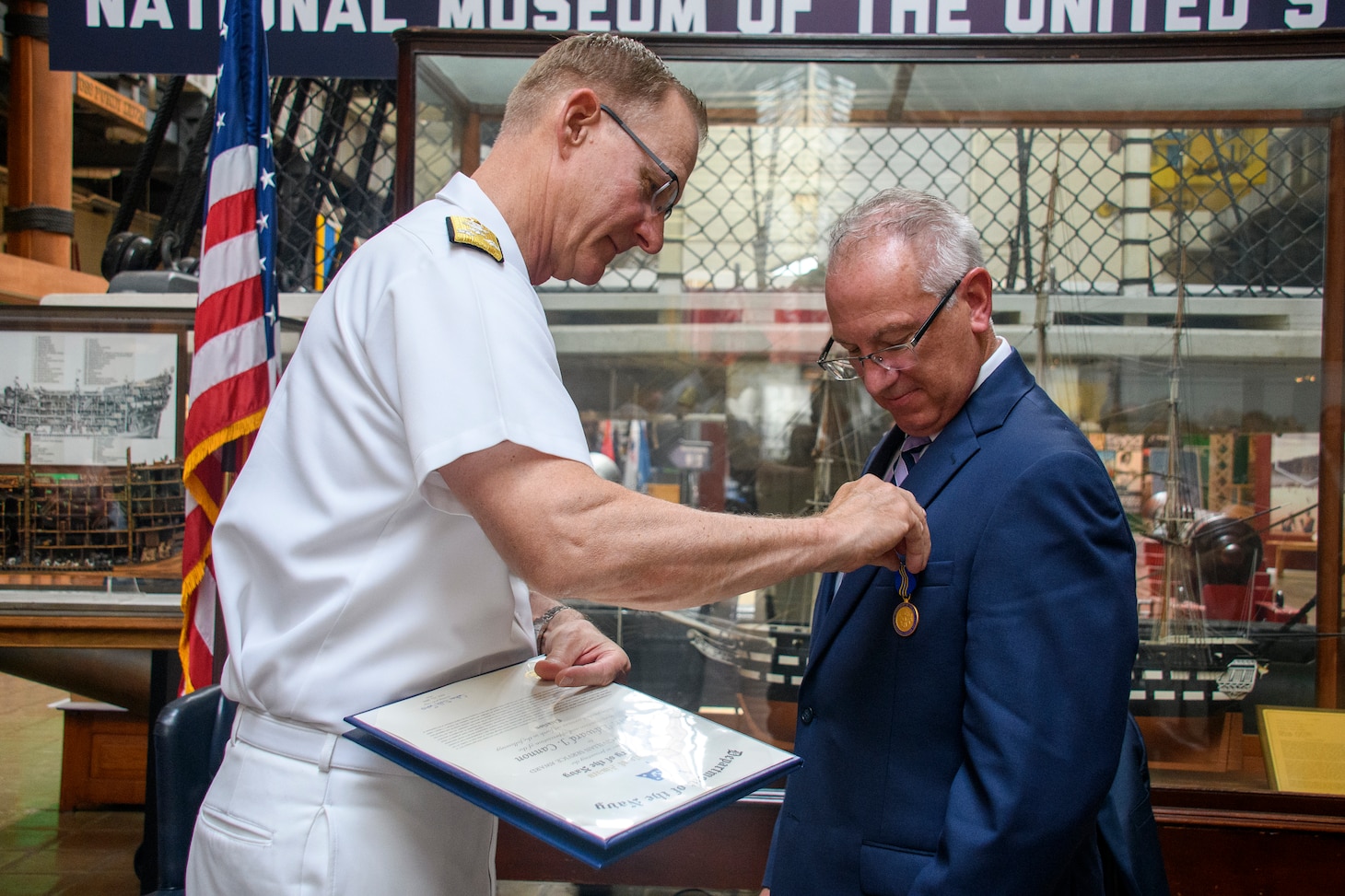 Mr. Edward Cannon, director of the Fleet & Family Readiness Program, receives the Distinguished Civil Service Award from Vice Adm. Yancy B. Lindsey, Commander, Navy Installations Command, at a retirement ceremony inside the U.S. Navy Museum at the historic Washington Navy Yard, D.C., July 21.