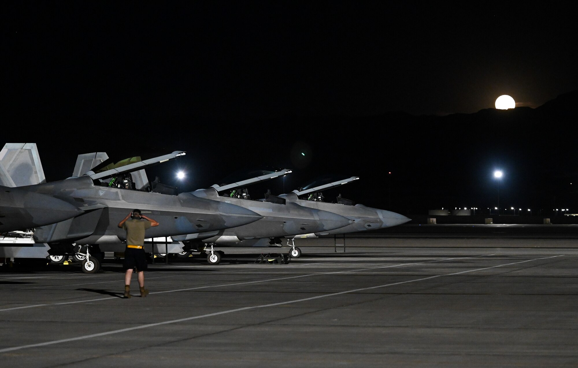 F-22 Raptors prepare to taxi on the flightline