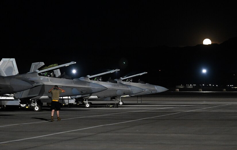 F-22 Raptors prepare to taxi on the flightline