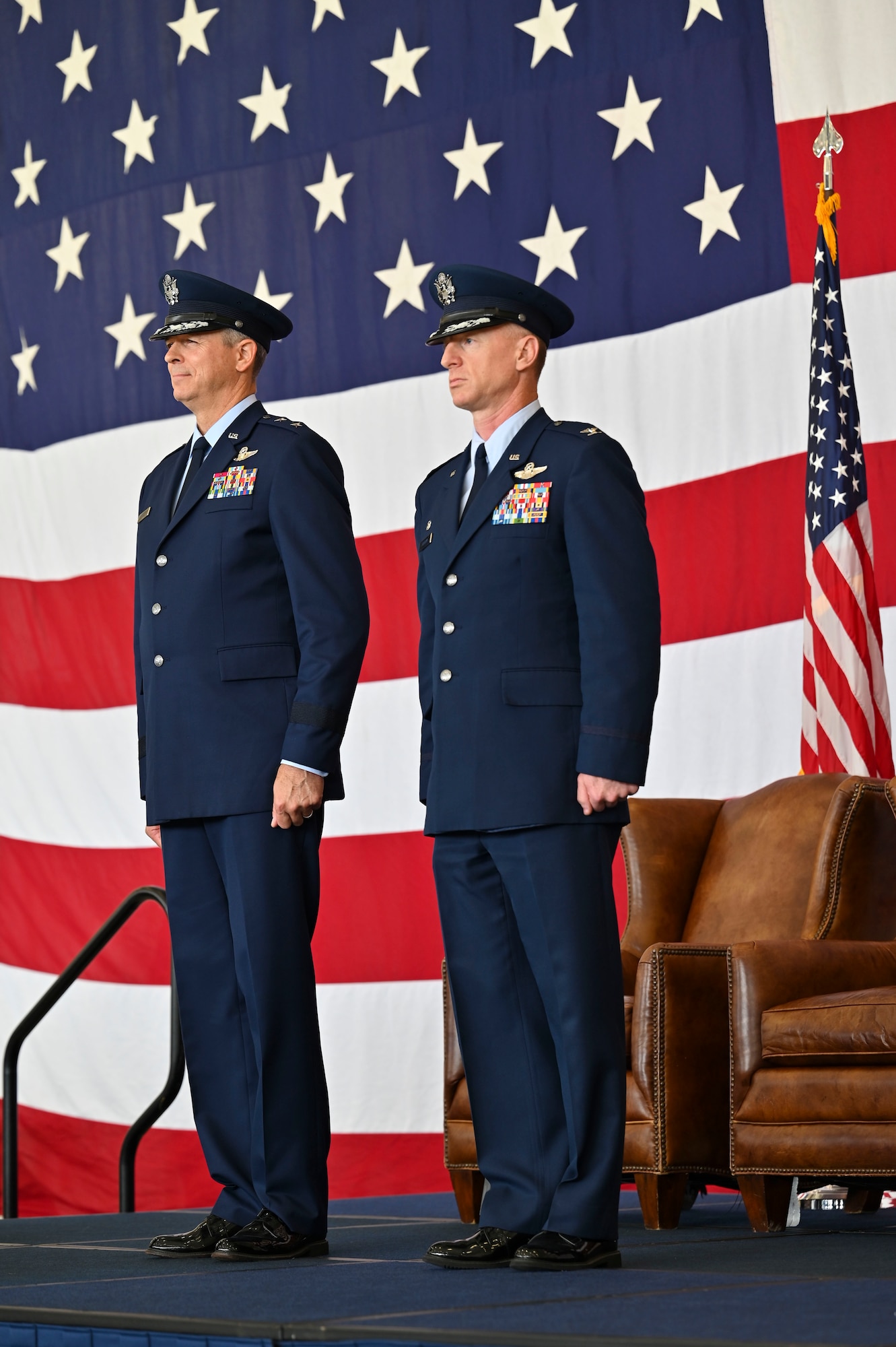 U.S. Air Force Maj. Gen. Craig Wills, 19th Air Force commander and Col. Seth Graham, outgoing 14th Flying Training Wing commander, stand at attention as the call to order is made for Graham to received the Legion of Merit, July 22, 2022, Columbus Air Force Base, Miss. Graham managed operations and a maintenance budget of $115 million with capital assets exceeding $2.3 billion during his time as commander. (U.S. Air Force photo by Senior Airman Jessica Haynie)