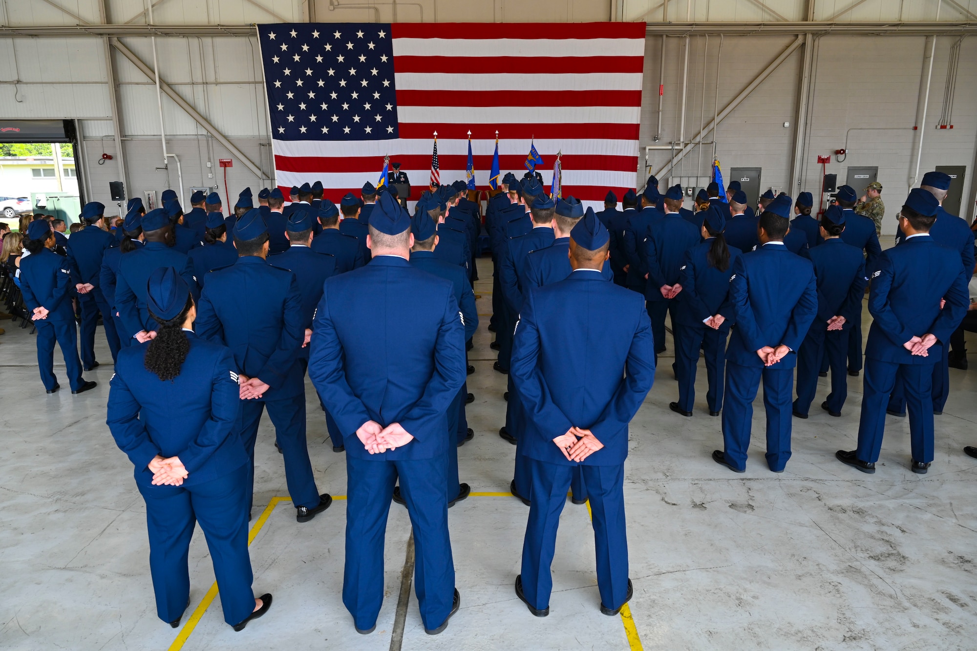Airmen of the 14th Flying Training Wing, stand at ease in formation during the 14FTW Change of Command ceremony on Columbus Air Force Base, Miss., July 22, 2022. The wing is composed of 244 aircraft flying more than 55,000 sorties and 77,000 hours per year while training over 400 pilots and combat system operators annually.( U.S. Air Force Senior Airman Jessica Haynie)