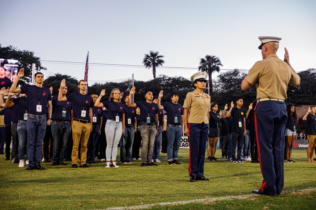Future Marines with Recruiting Station San Diego take the Oath of Enlistment during a soccer game at the Torero Stadium, San Diego, California, July 9, 2022. The Oath of Enlistment solidifies their promise to support and defend the Constitution. (U.S. Marine Corps photo by Cpl. Emely Gonzalez)