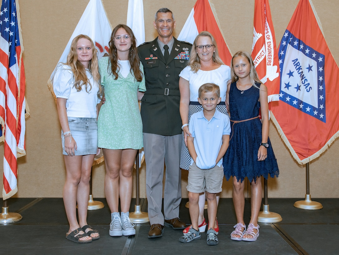 Memphis District Commander Col. Brian Sawser and his family, wife Susanne, daughter Sophia, daughter Helena, daughter Johanna, and son Jonathan pose for a family portrait on the stage following the Assumption of Command Ceremony, July 22, at the Renasant Center in downtown Memphis.