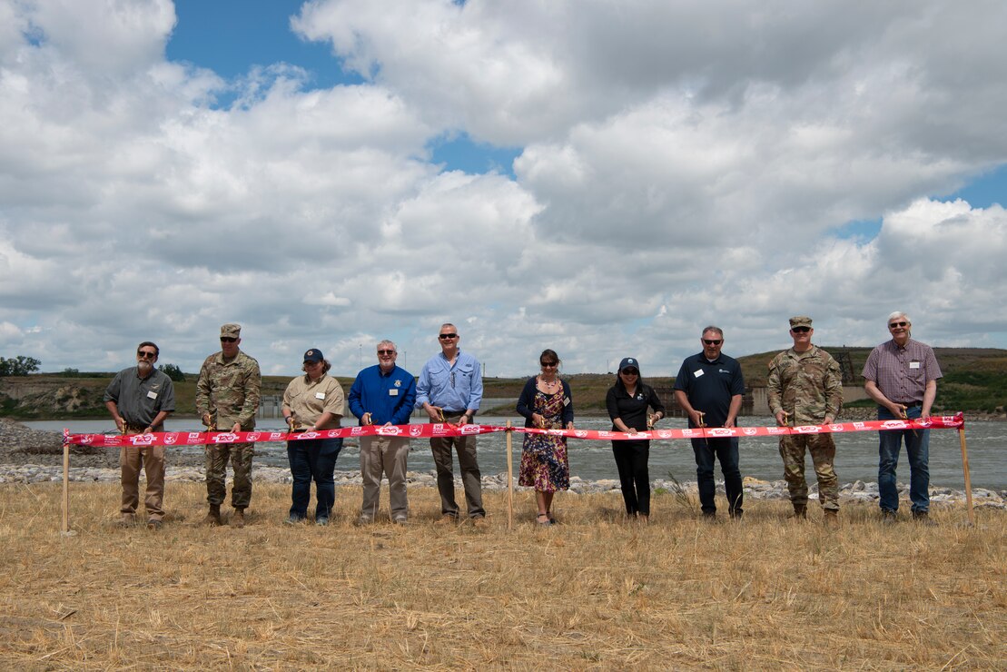 Leadership from the Department of Interior, the  U.S. Army Corps of Engineers, and the U.S. Bureau of Reclamation, cut the ribbon during the ribbon cutting ceremony for the Lower Yellowstone Bypass Channel in Glendive, Mont., July 26, 2022. (U.S. Army Corps of Engineers Photo by Jason Colbert)