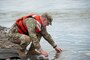Col. Geoff Van Epps, Commander, U.S. Army Corps of Engineers Northwestern Division, releases a pallid sturgeon during the ribbon cutting ceremony for the Lower Yellowstone Bypass Channel in Glendive, Mont., July 26, 2022. (U.S. Army Corps of Engineers Photo by Jason Colbert)