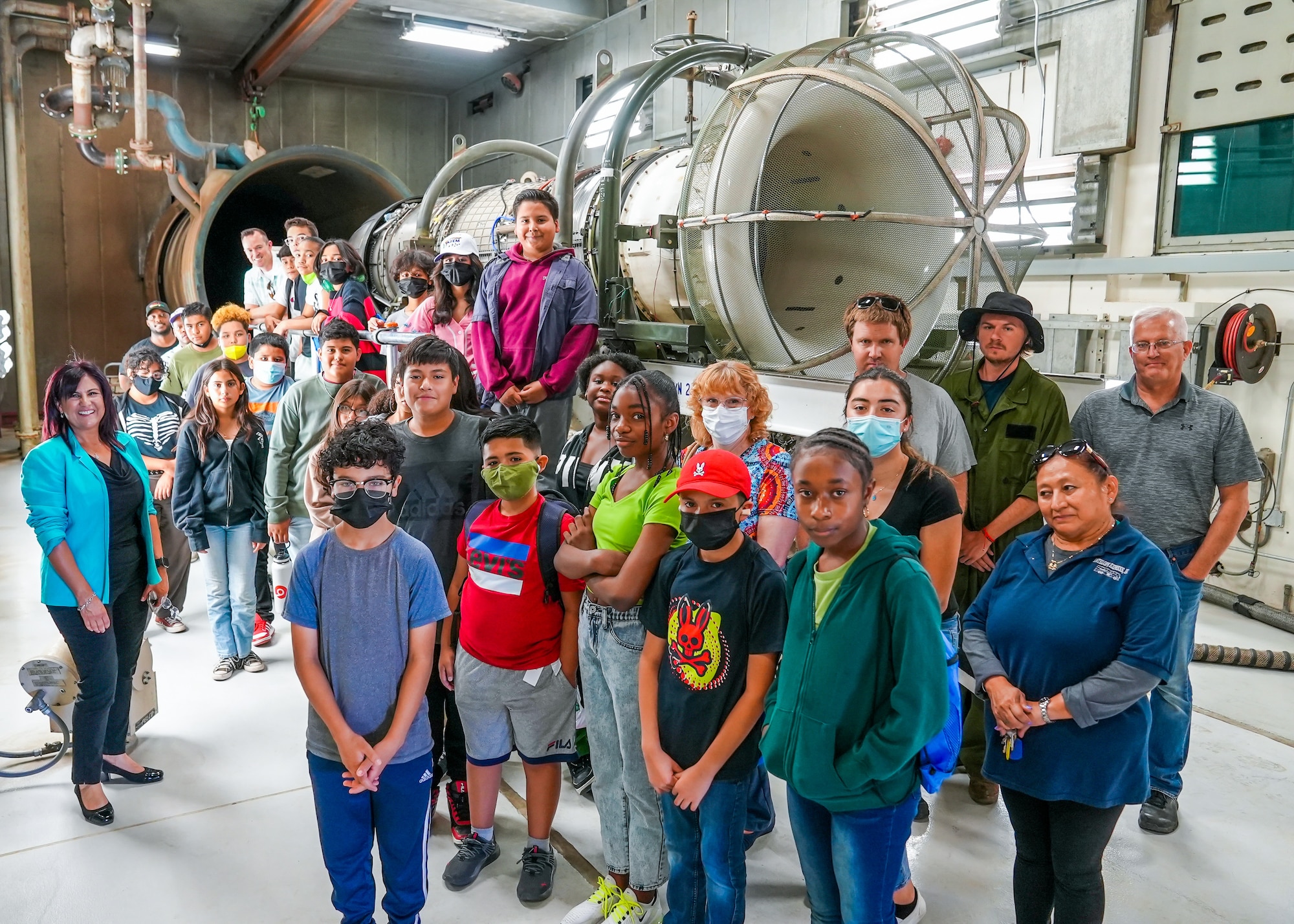 PRIME students pose for photo with a jet engine during a visit to the 412th Maintenance Squadron Propulsion Flight on Edwards Air Force Base, California, June 27. The tour helped kids understand the correlation between math and STEM careers on base. (Air Force photo by Carol Otero)