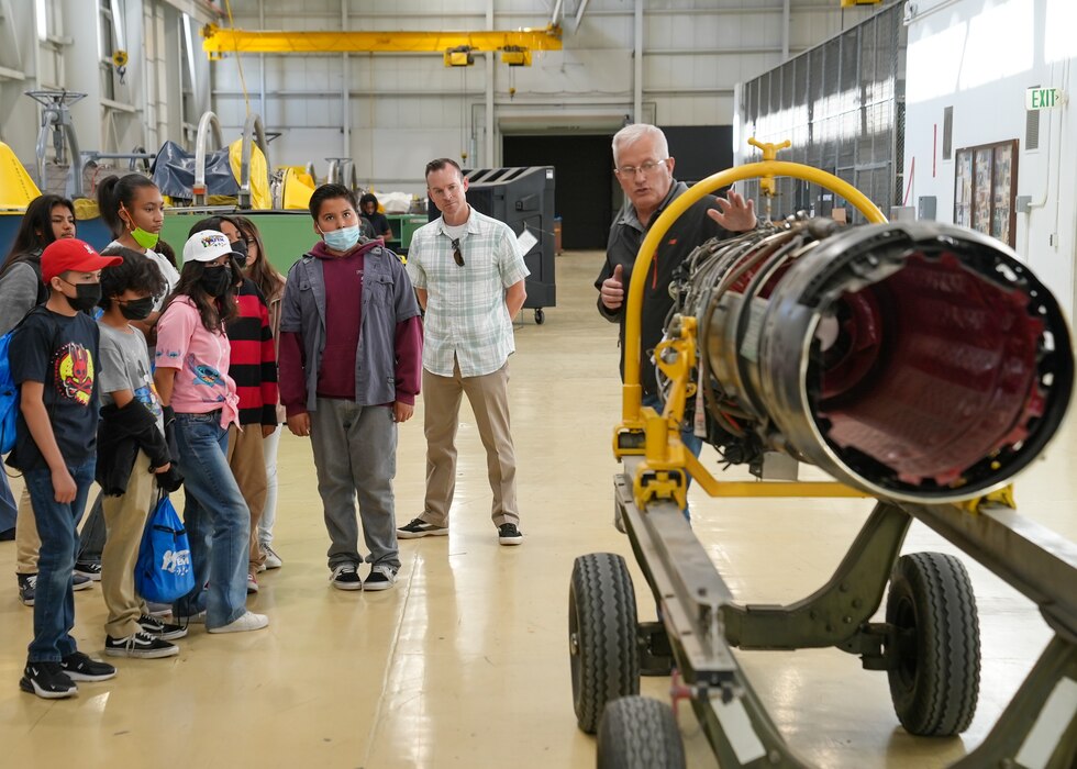 Greg Peria, 412th Maintenance Squadron Propulsion Flight Chief, describes a jet engine to a group of PRIME students during a visit to Edwards Air Force Base, California, June 27. Promoting Relevance and Interest in Mathematics Experiences, or PRIME, is a pilot program designed to prepare students for high school algebra. (Air Force photo by Carol Otero)
