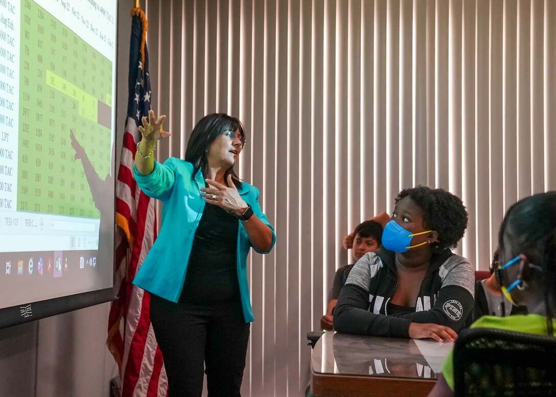 Edwards AFB STEM coordinator Helida Vanhoy, describes how STEM, specifically math, plays a role in the 412th Maintenance Squadron’s Propulsion Flight at Edwards Air Force Base, California, June 27. (Air Force photo by Carol Otero)